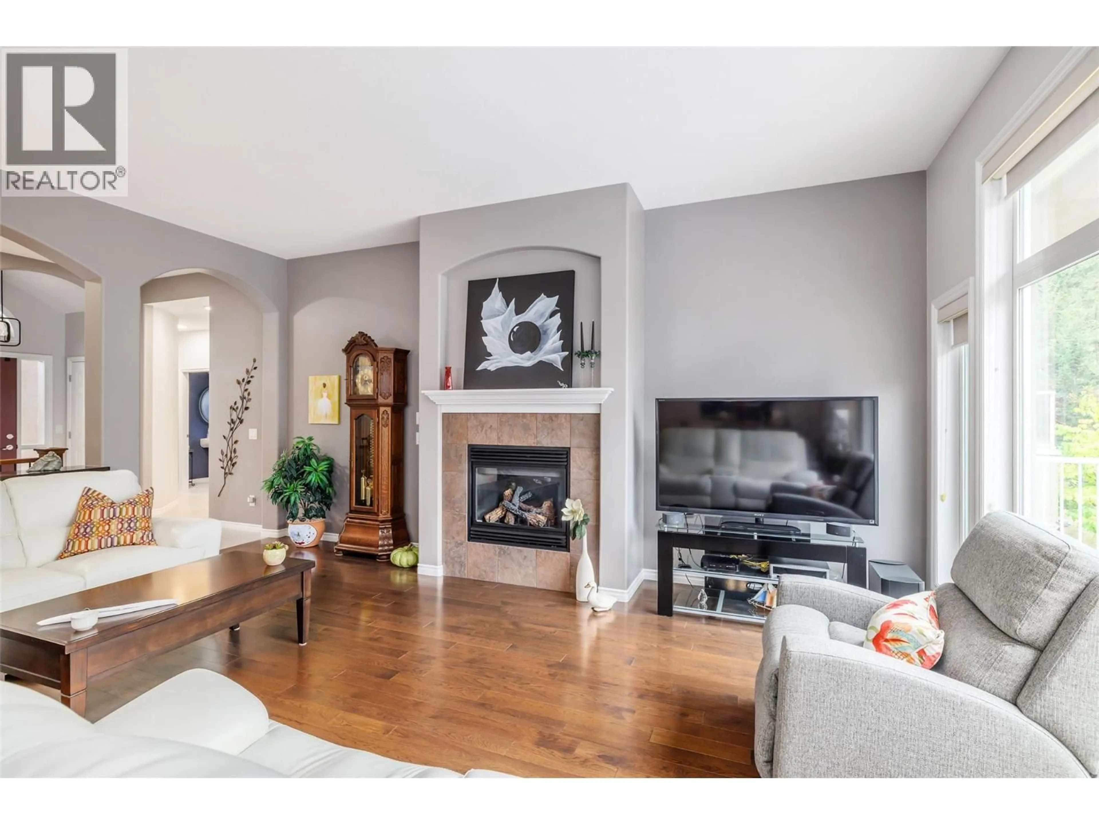 Living room with furniture, wood/laminate floor for 4170 GALLAGHERS FOREST SOUTH CRESCENT, Kelowna British Columbia V1W5E4