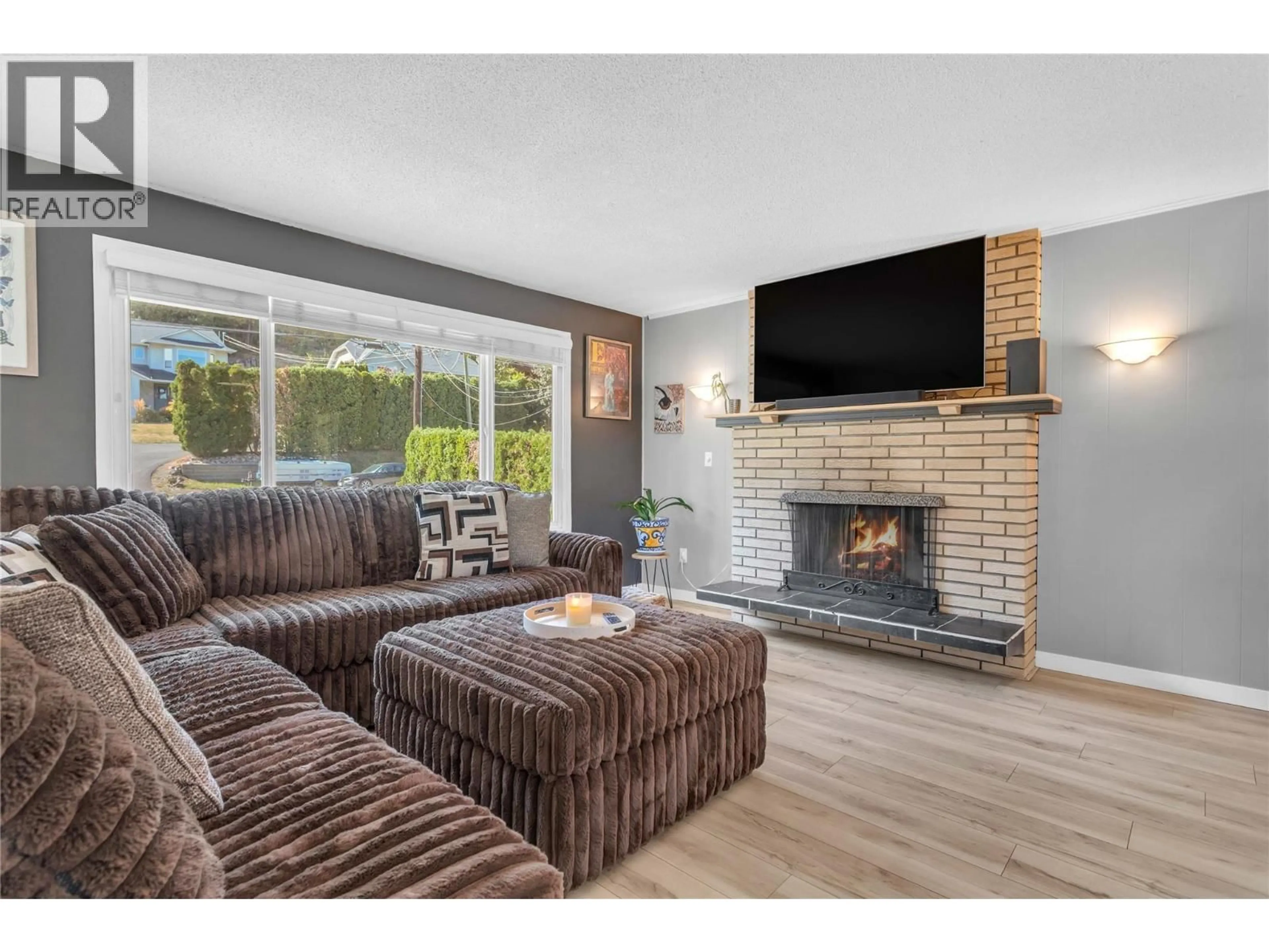 Living room with furniture, wood/laminate floor for 3227 MCIVER ROAD, West Kelowna British Columbia V4T1G1
