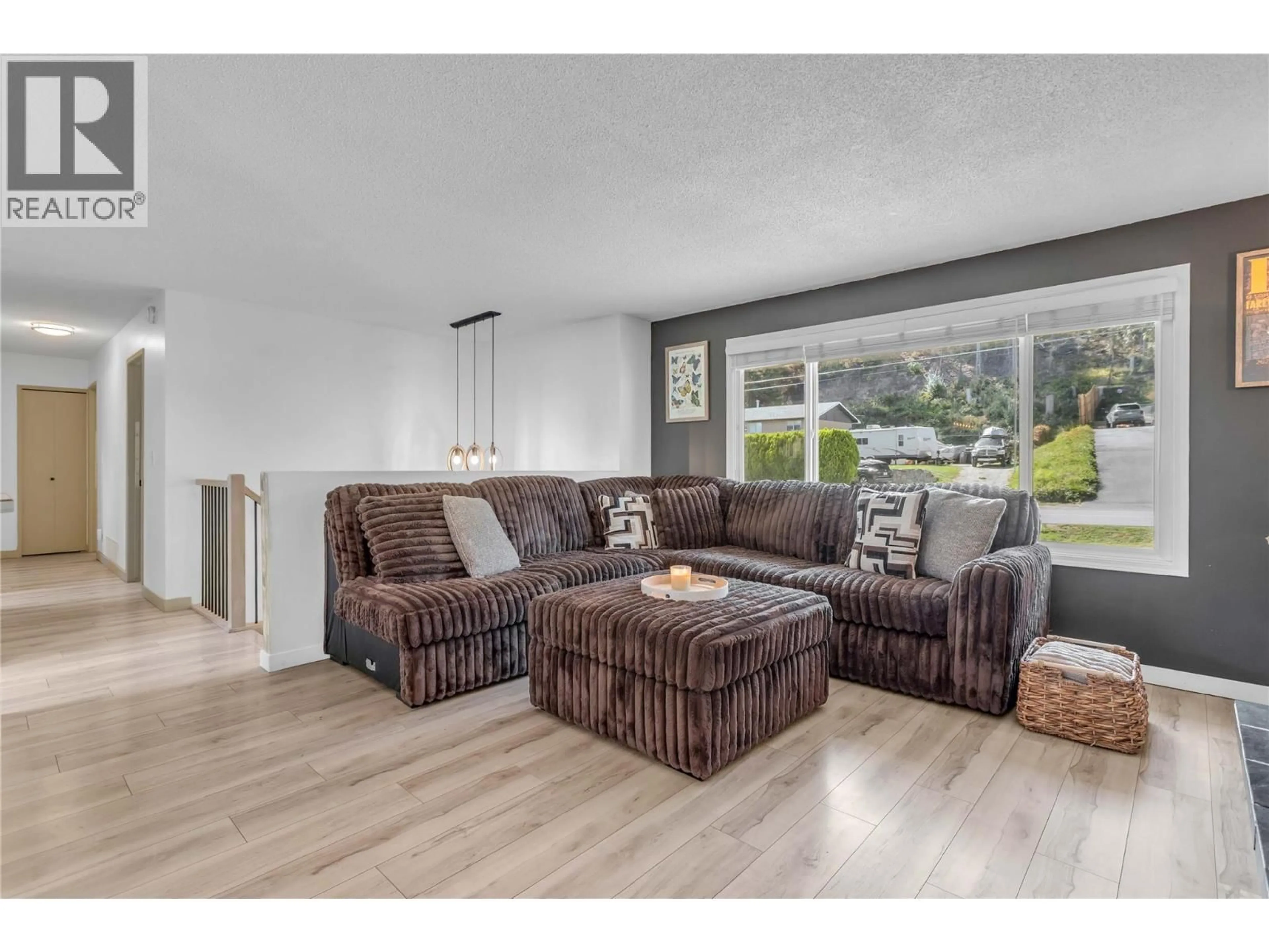 Living room with furniture, wood/laminate floor for 3227 MCIVER ROAD, West Kelowna British Columbia V4T1G1