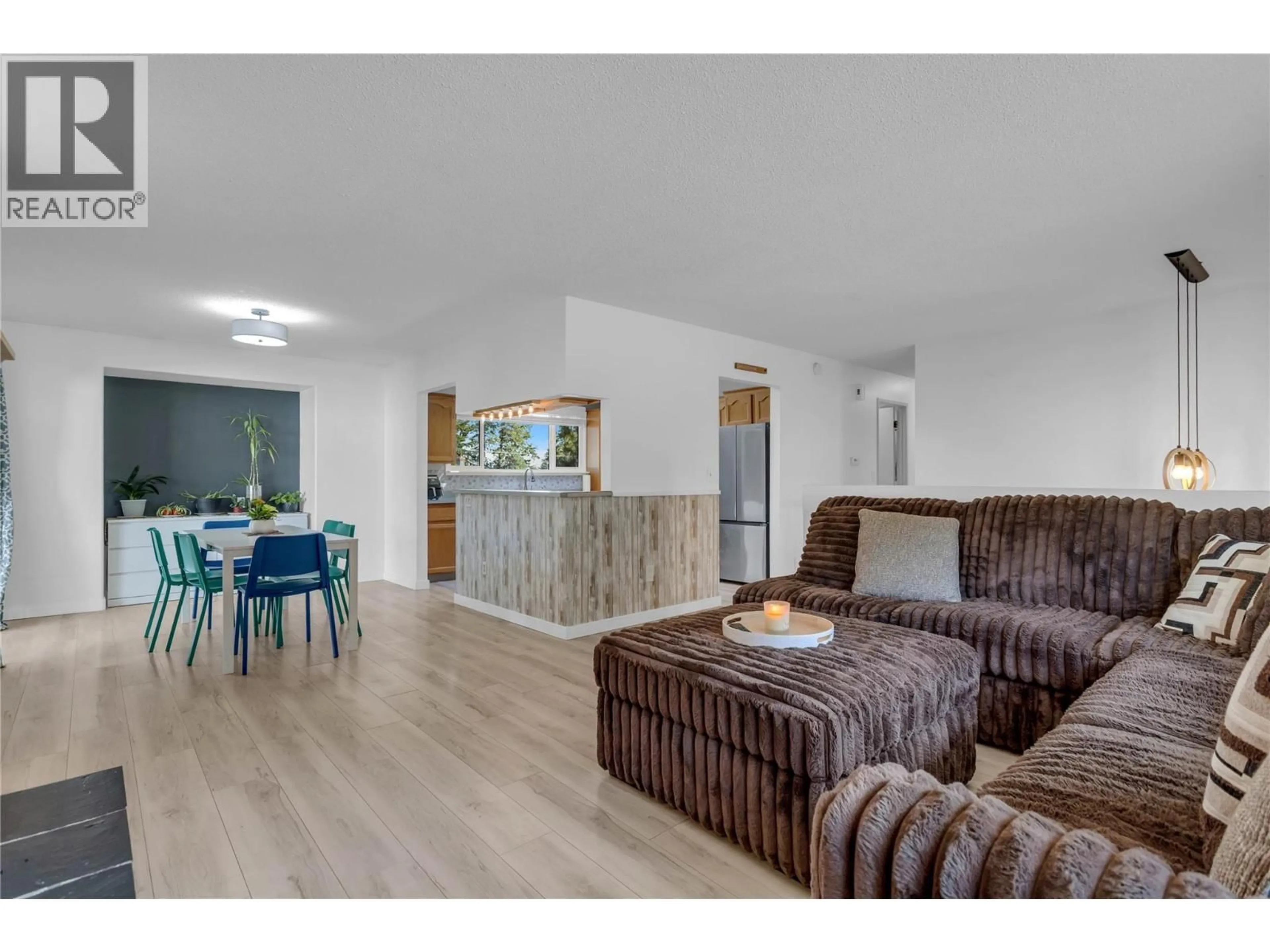 Living room with furniture, wood/laminate floor for 3227 MCIVER ROAD, West Kelowna British Columbia V4T1G1