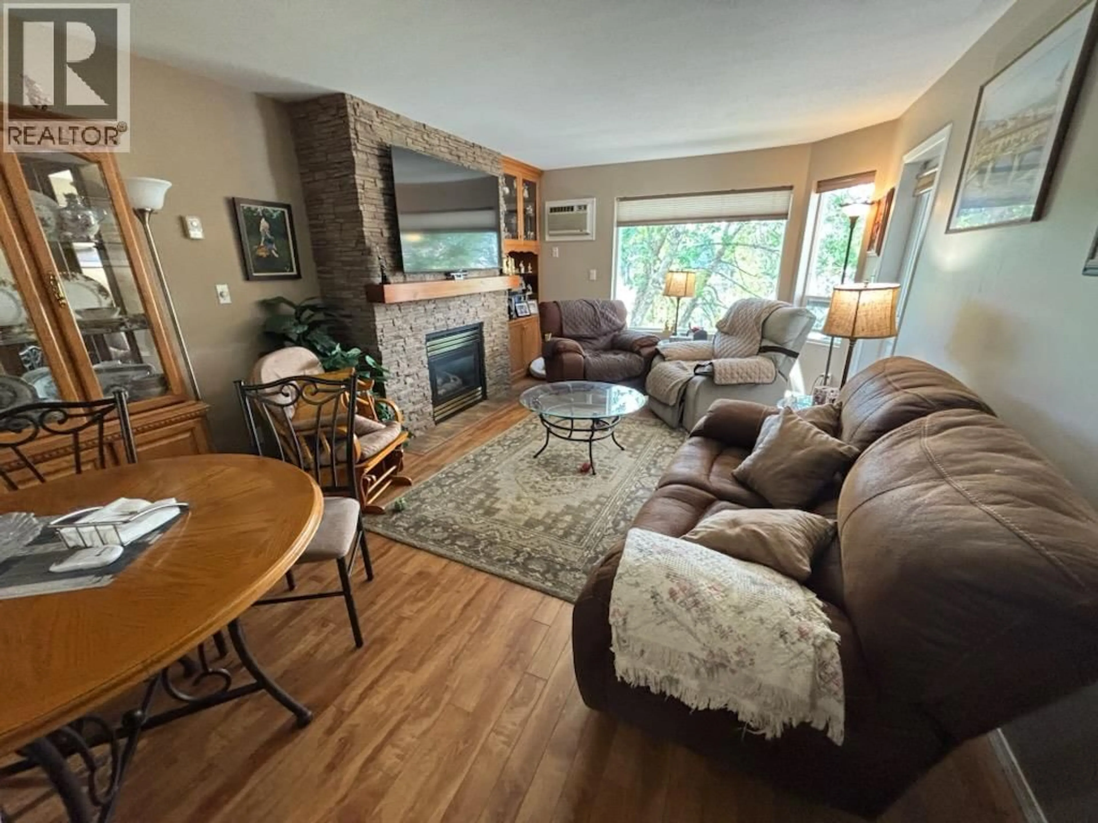 Living room with furniture, wood/laminate floor for 303 - 7140 4TH STREET, Grand Forks British Columbia V0H1H0