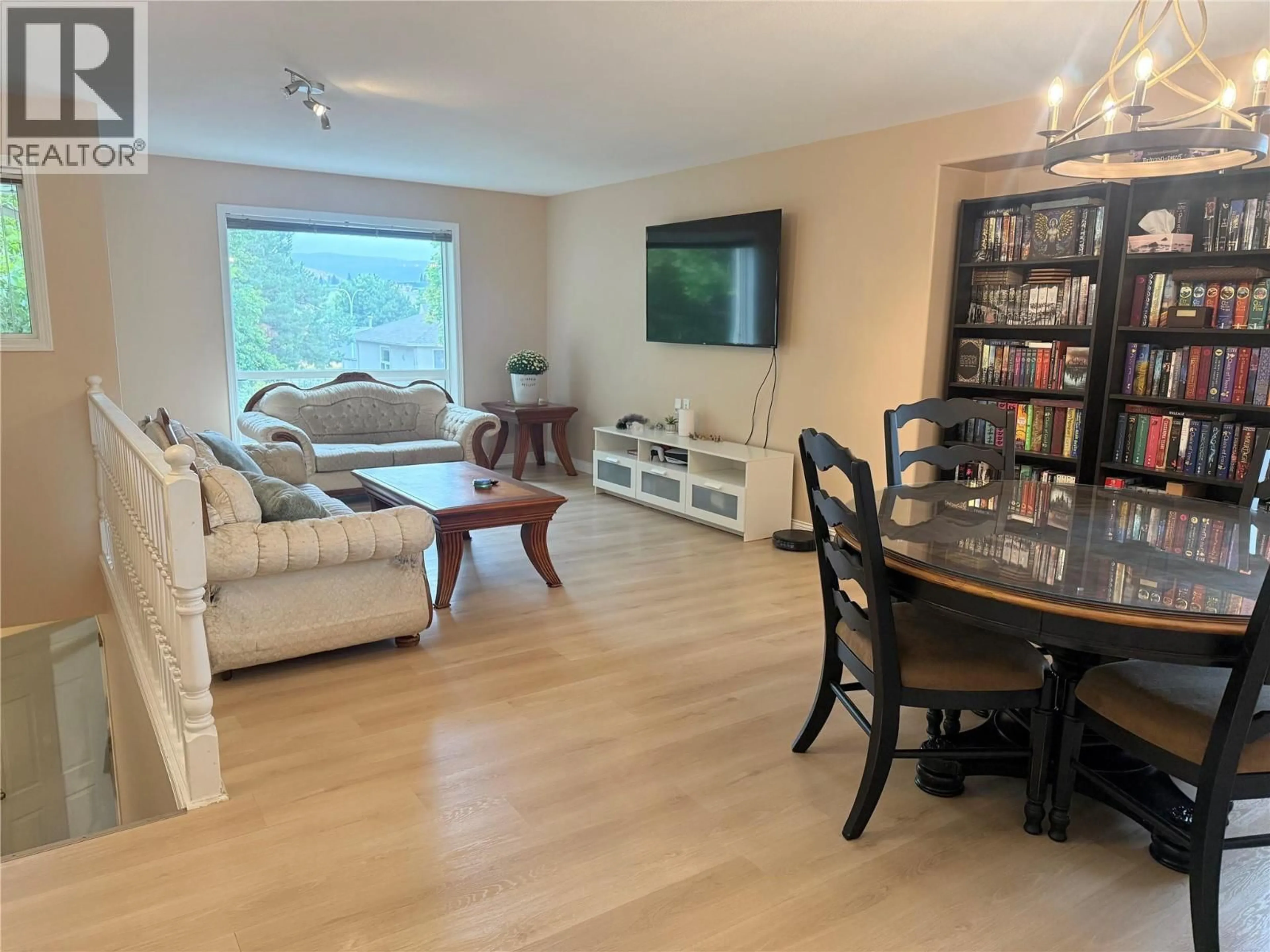 Living room with furniture, wood/laminate floor for 154 RITCHIE COURT, Kelowna British Columbia V1V1Z2