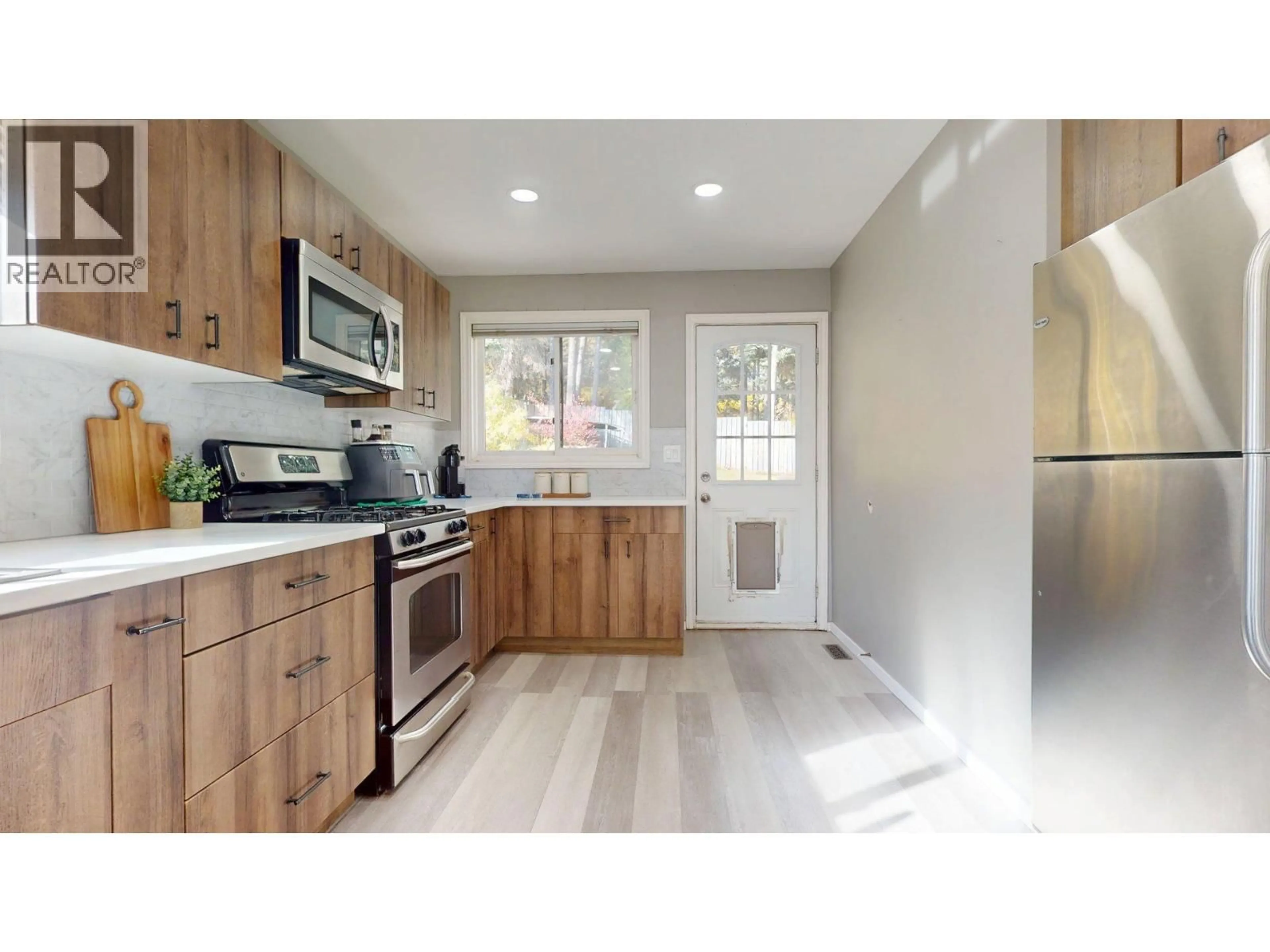 Open concept kitchen, wood/laminate floor for 1237 PINYON ROAD, Sparwood British Columbia V0B2G2