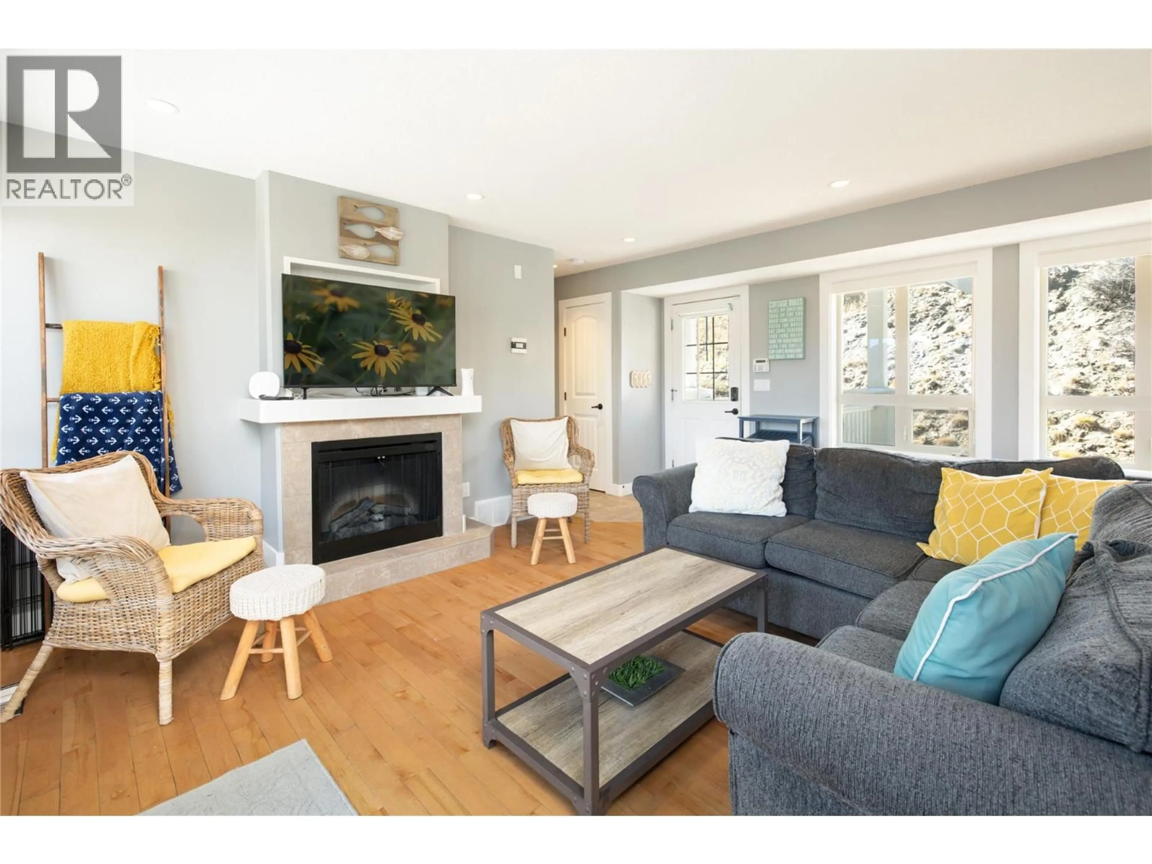 Living room with furniture, wood/laminate floor for 216 - 6773 LA PALMA LOOP, Kelowna British Columbia V1Z3R8