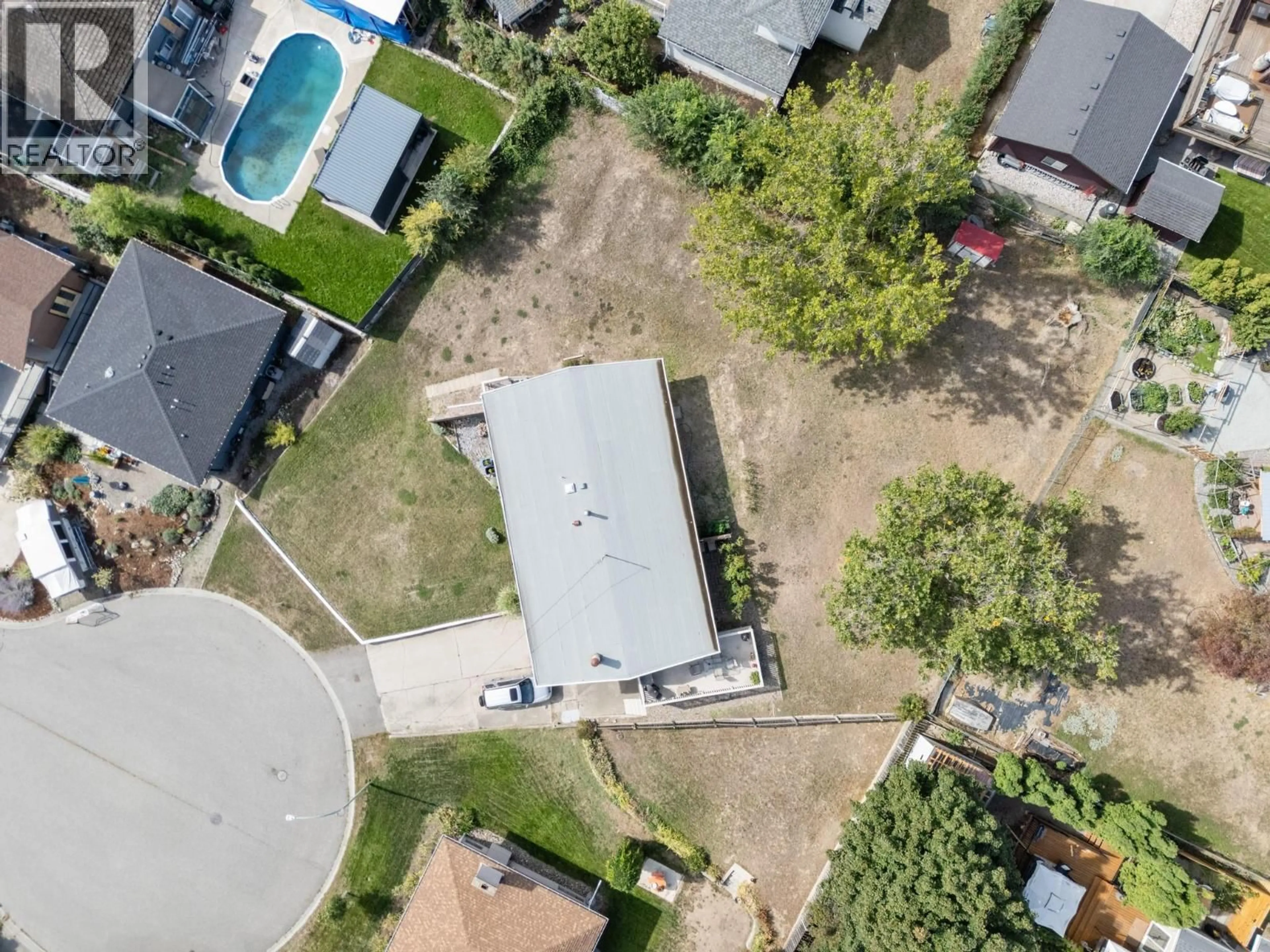A pic from outside/outdoor area/front of a property/back of a property/a pic from drone, street for 1440 GLENAIRE CRESCENT, Kelowna British Columbia V1Y3N1