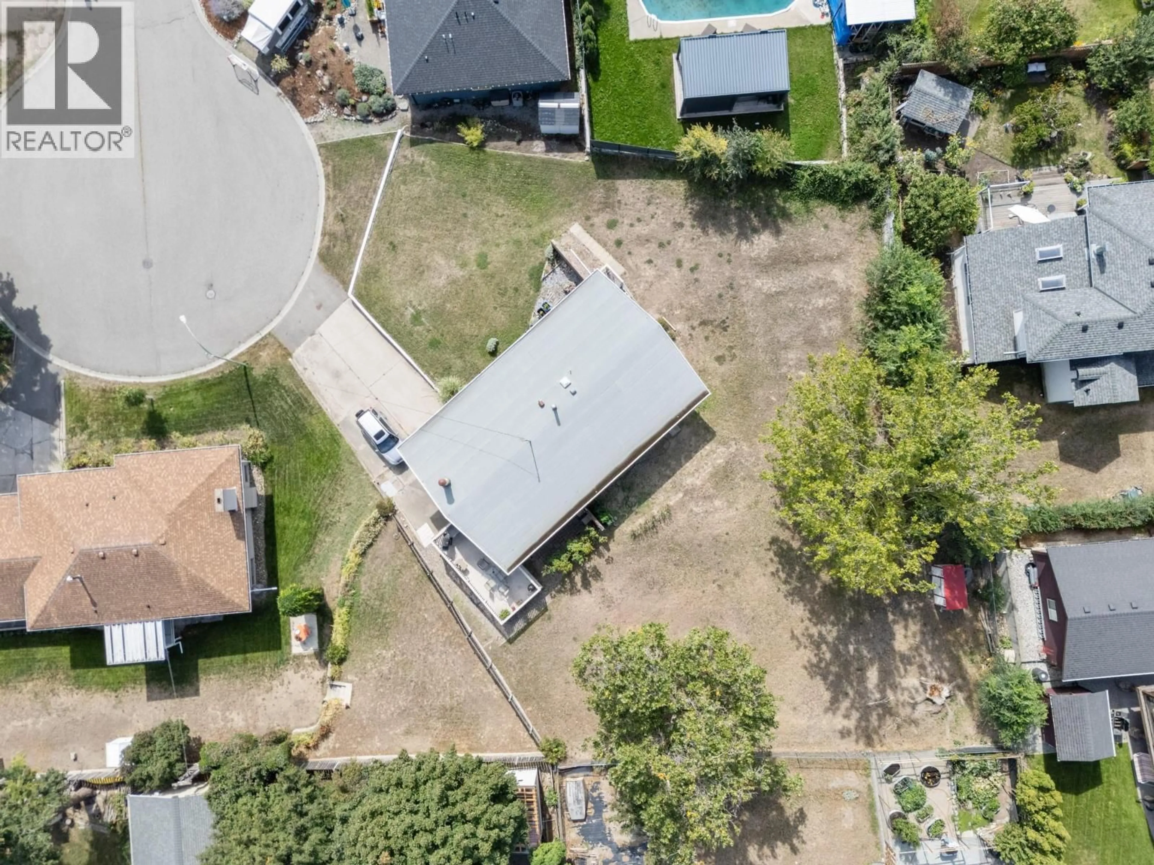 A pic from outside/outdoor area/front of a property/back of a property/a pic from drone, street for 1440 GLENAIRE CRESCENT, Kelowna British Columbia V1Y3N1