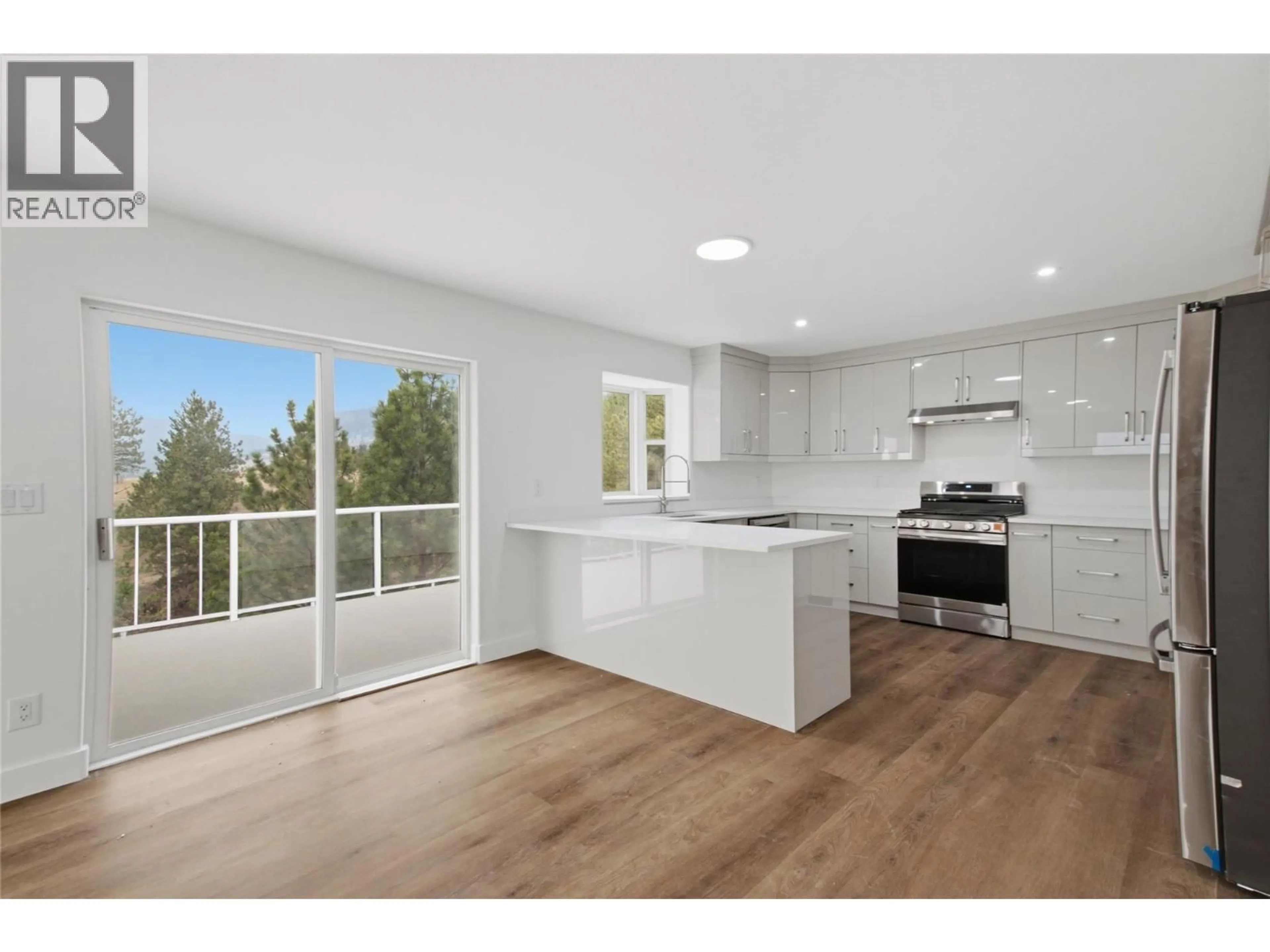 Open concept kitchen, wood/laminate floor for 7035 BLACKWELL ROAD, Kamloops British Columbia V2C6V8