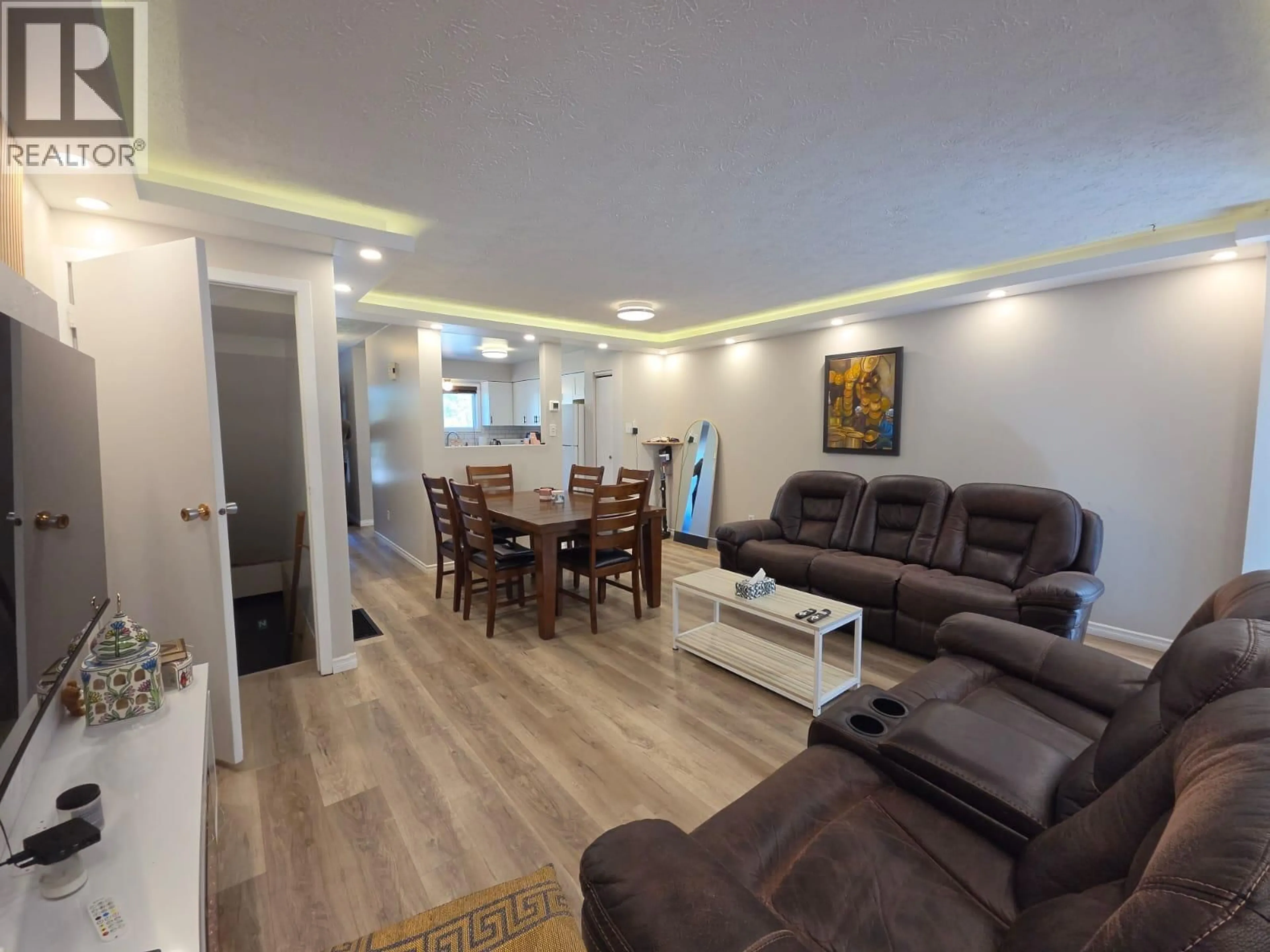Living room with furniture, wood/laminate floor for 240 SPIEKER AVENUE, Tumbler Ridge British Columbia V0C2W0