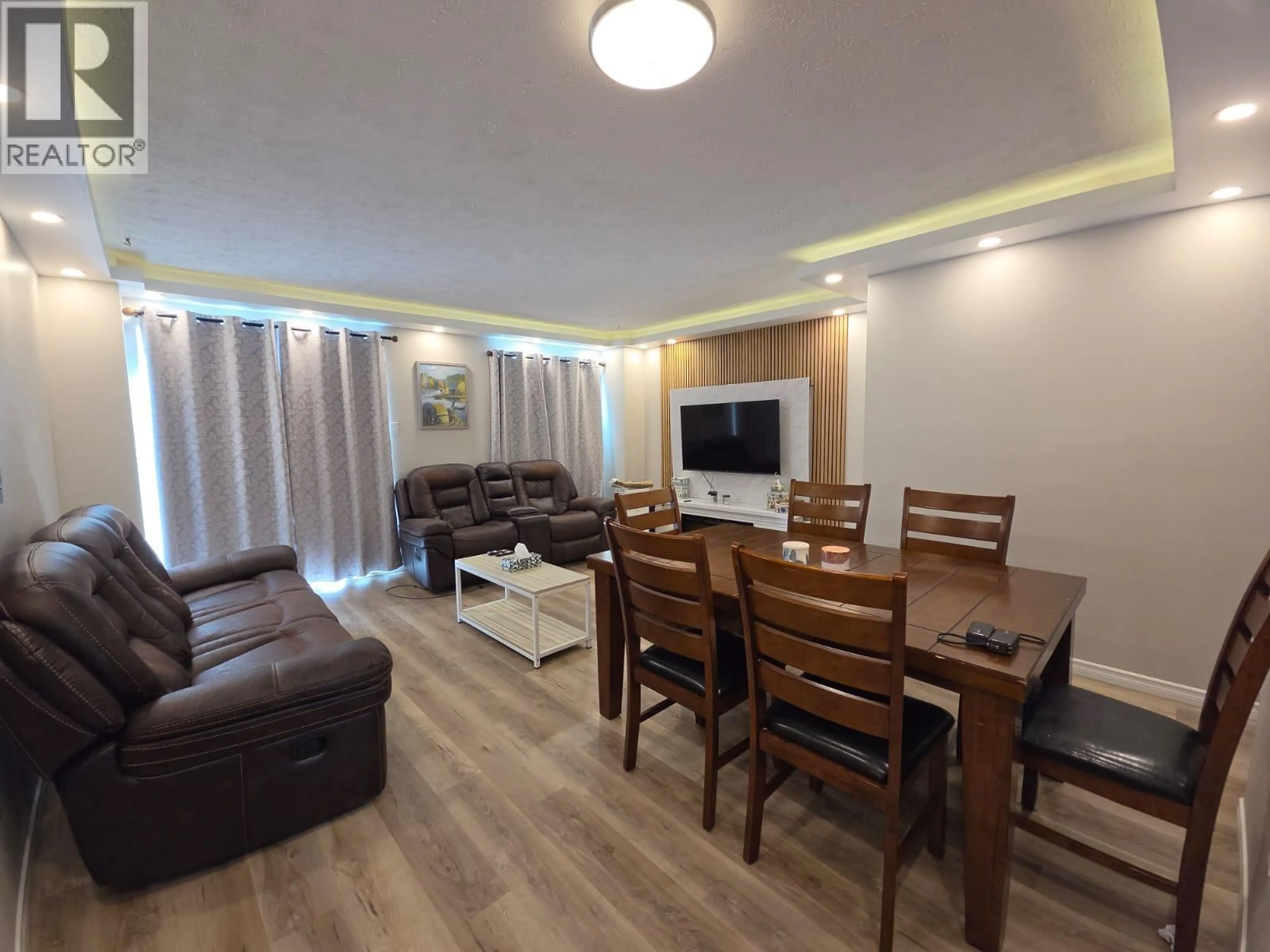 Living room with furniture, wood/laminate floor for 240 SPIEKER AVENUE, Tumbler Ridge British Columbia V0C2W0