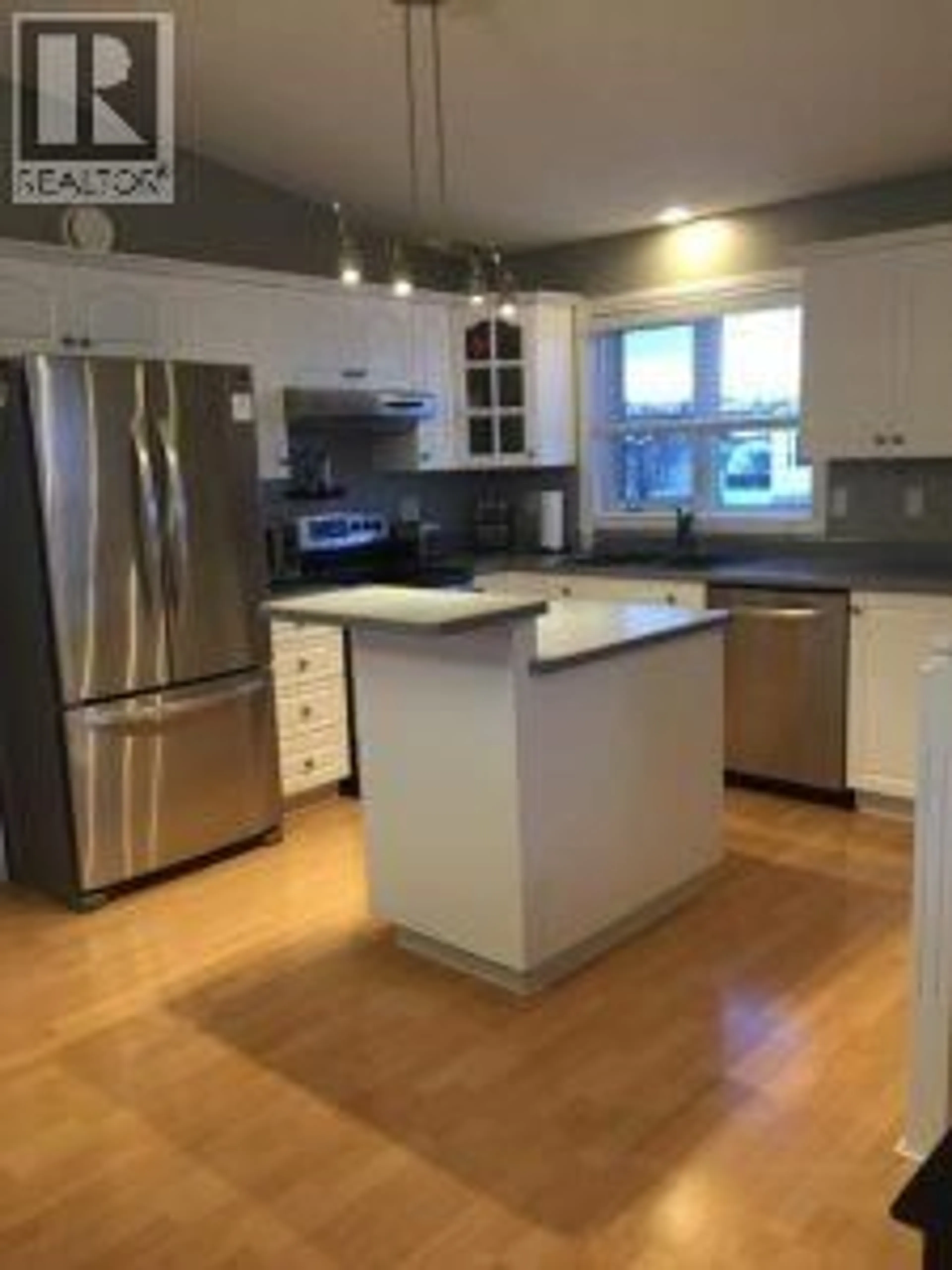 Open concept kitchen, wood/laminate floor for 10717 CYPRUS COURT, Dawson Creek British Columbia V1G4N1