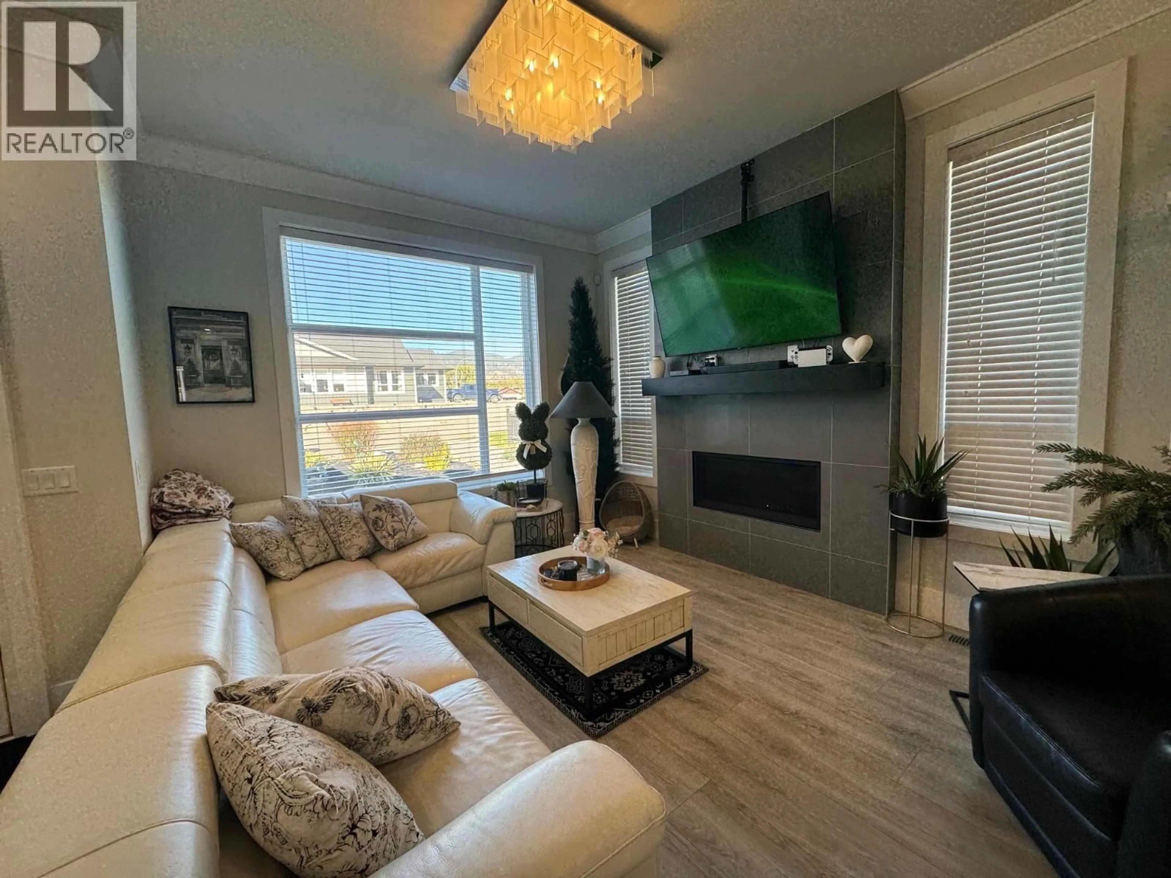 Living room with furniture, wood/laminate floor for 1610 CHESTNUT AVENUE, Merritt British Columbia V1K0A9