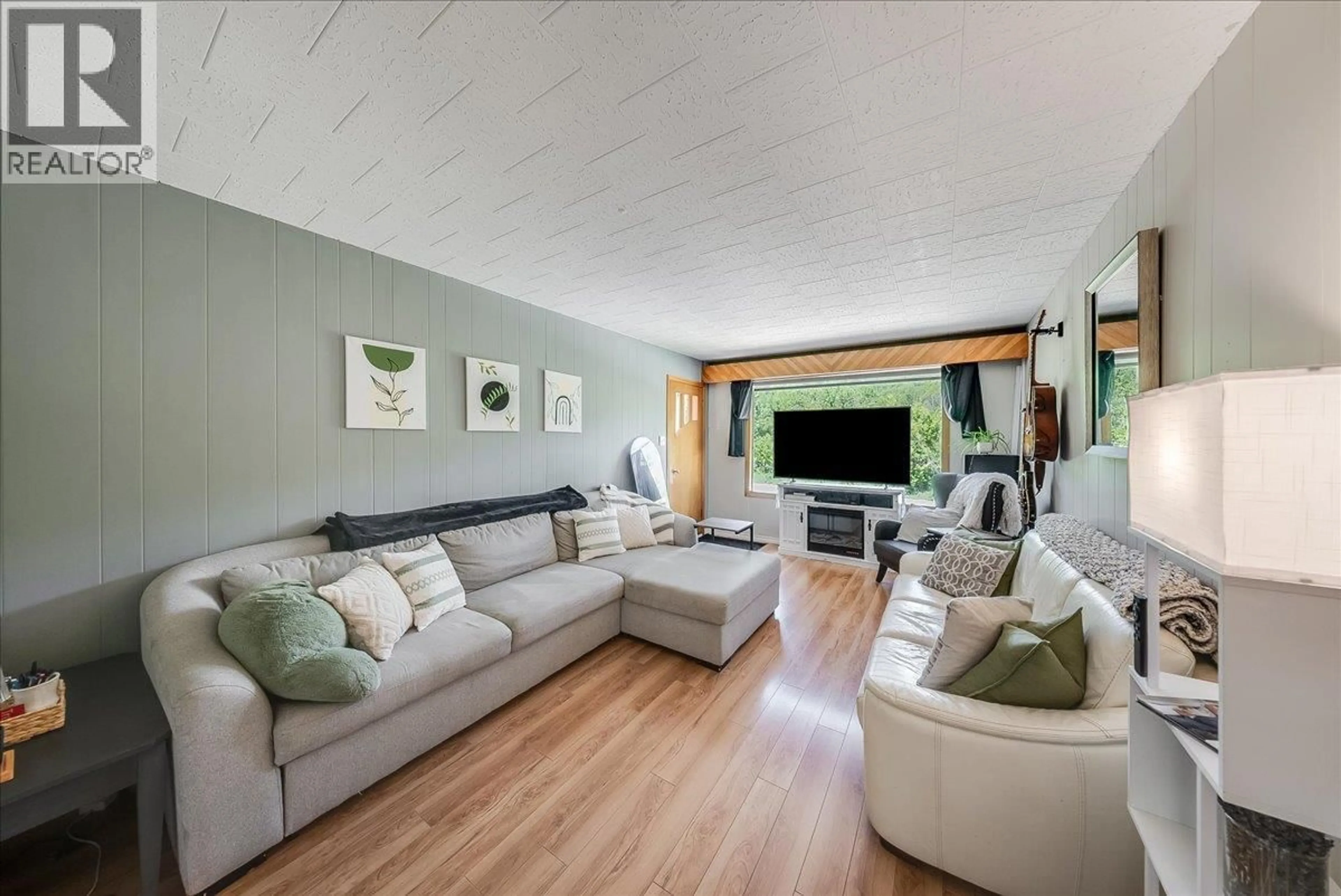 Living room with furniture, wood/laminate floor for 128 HAIG STREET, Warfield British Columbia V1R2L9