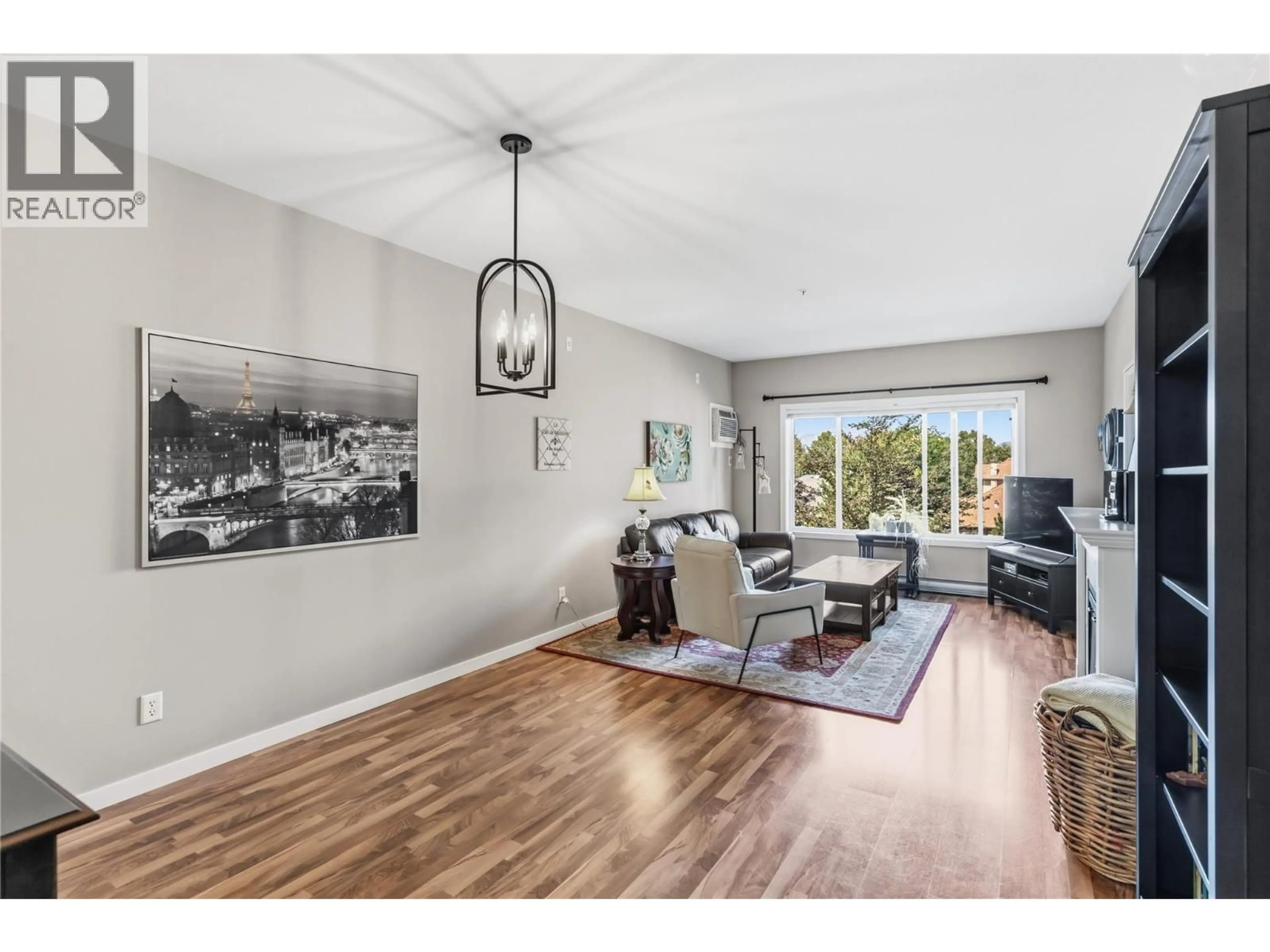 Living room with furniture, wood/laminate floor for 301 - 688 LEQUIME ROAD, Kelowna British Columbia V1W1A4