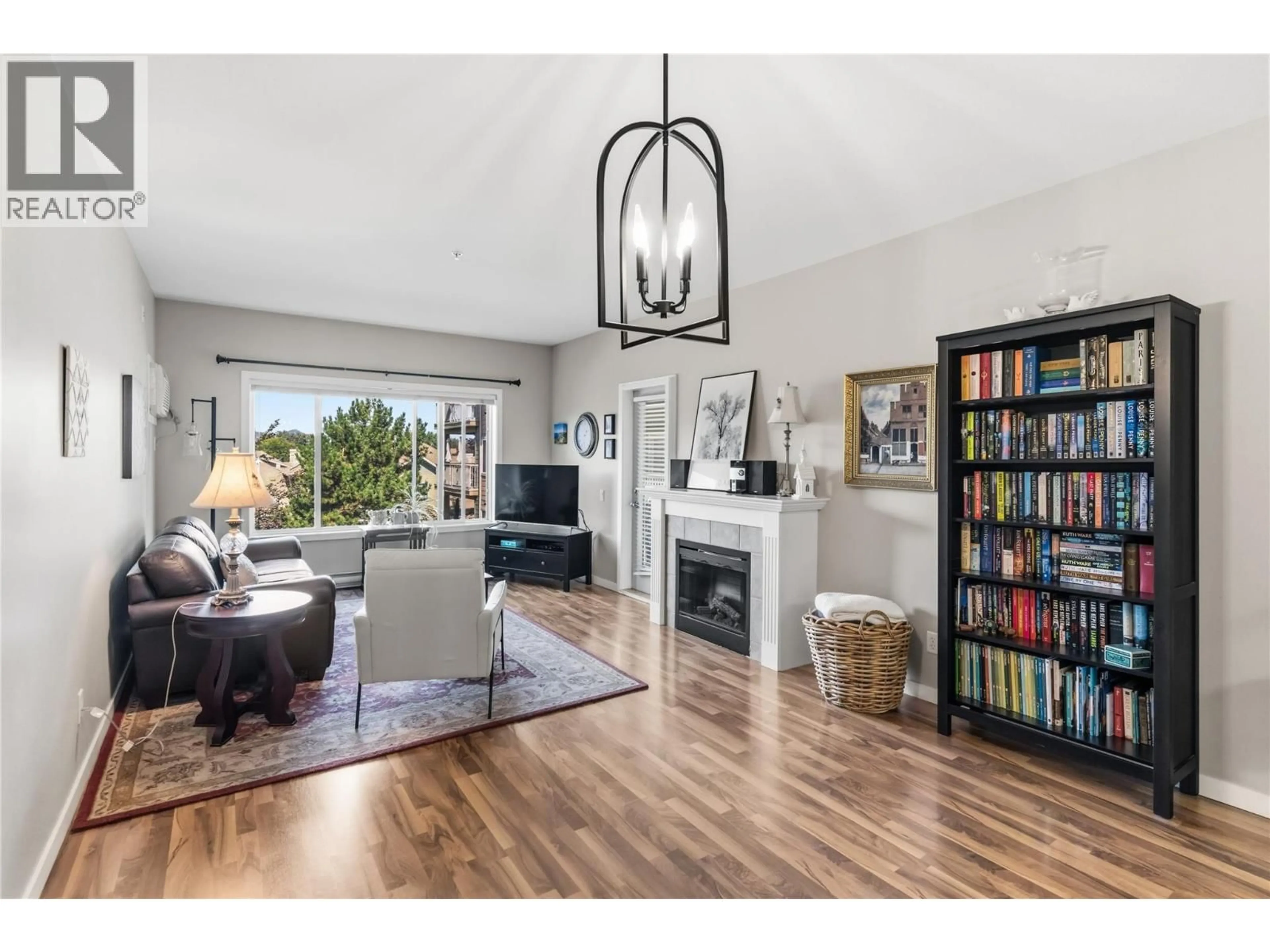 Living room with furniture, wood/laminate floor for 301 - 688 LEQUIME ROAD, Kelowna British Columbia V1W1A4