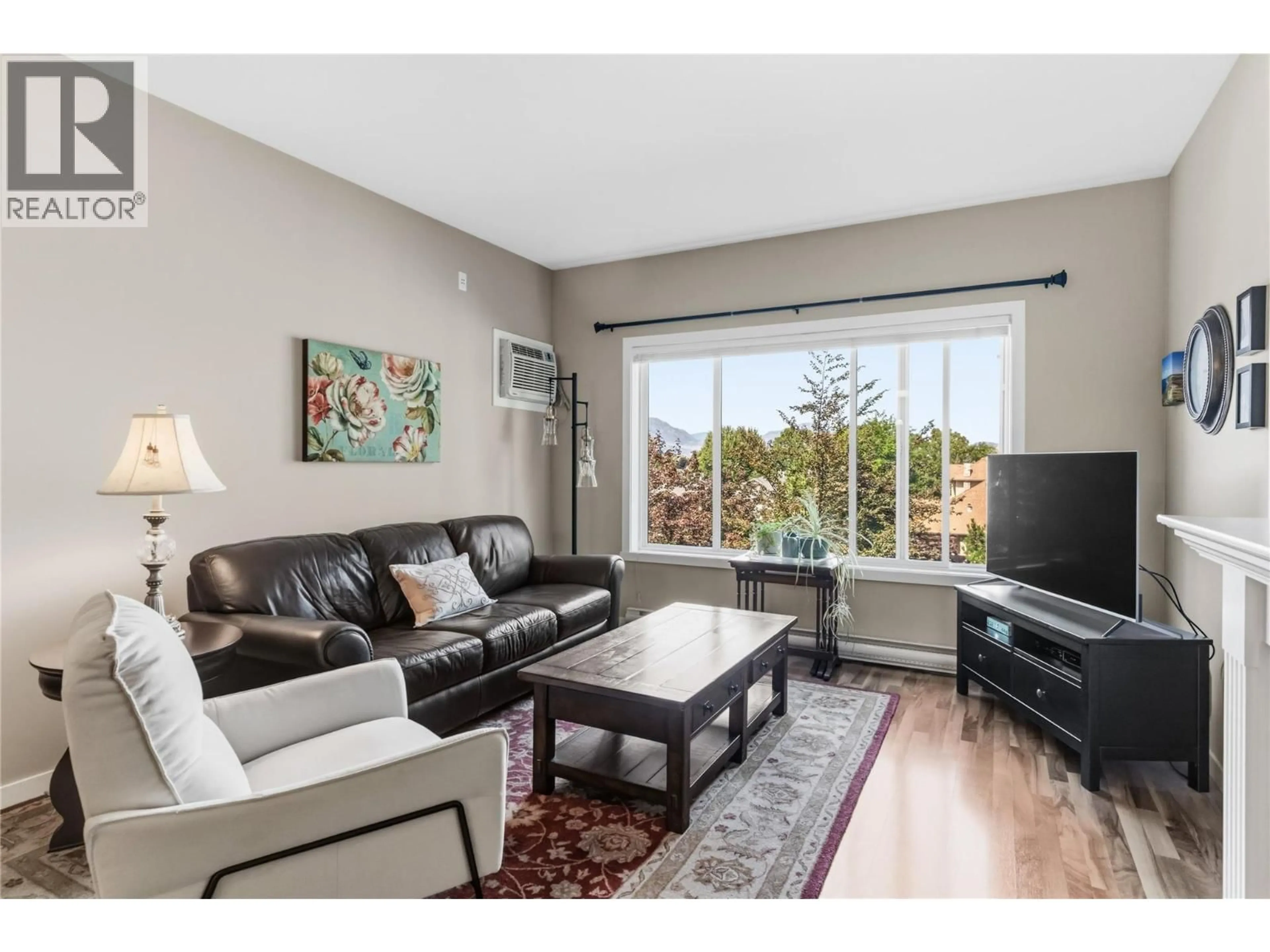 Living room with furniture, wood/laminate floor for 301 - 688 LEQUIME ROAD, Kelowna British Columbia V1W1A4