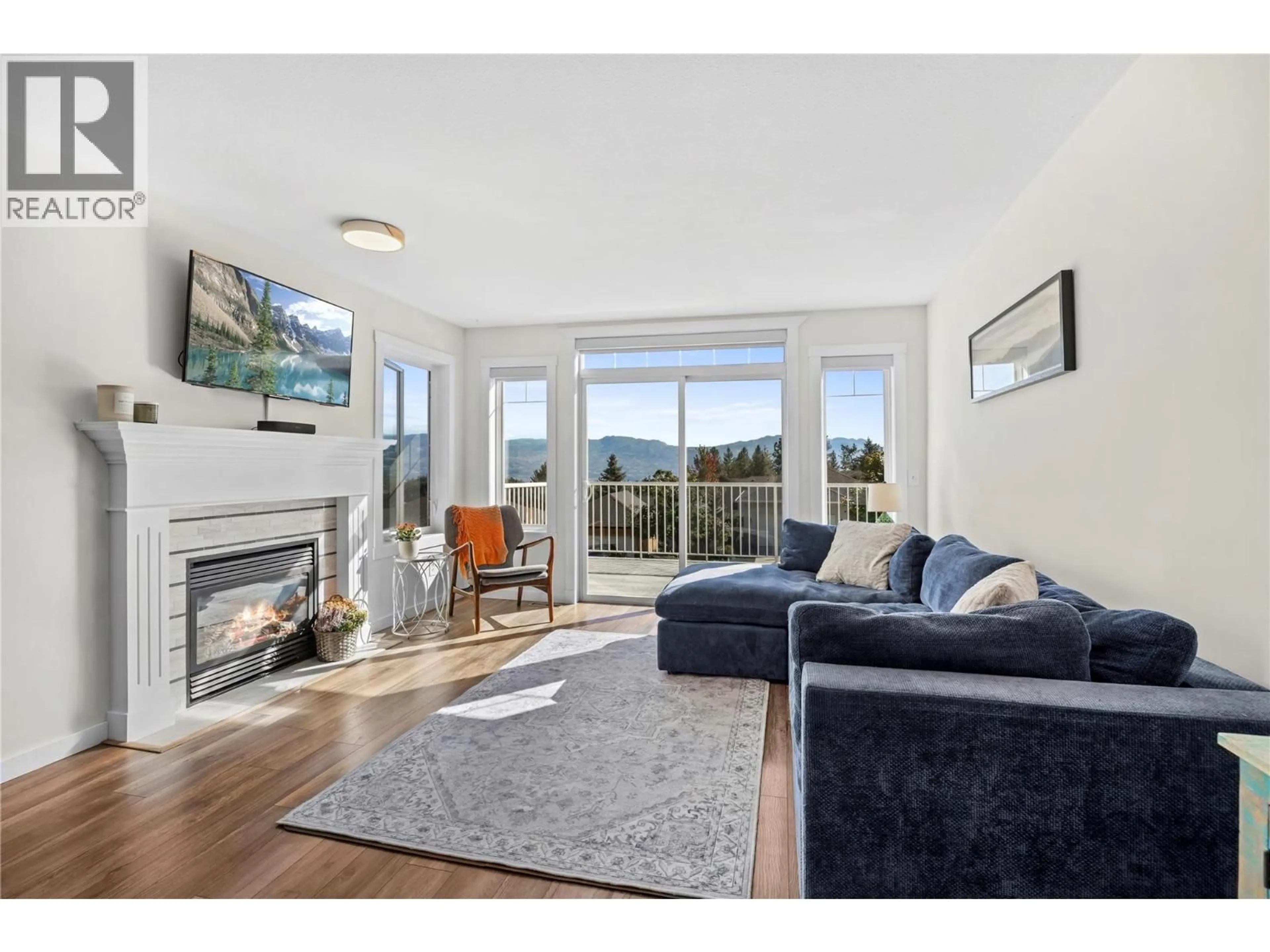 Living room with furniture, wood/laminate floor for 2322 SHANNON HEIGHTS PLACE, West Kelowna British Columbia V4T2V2