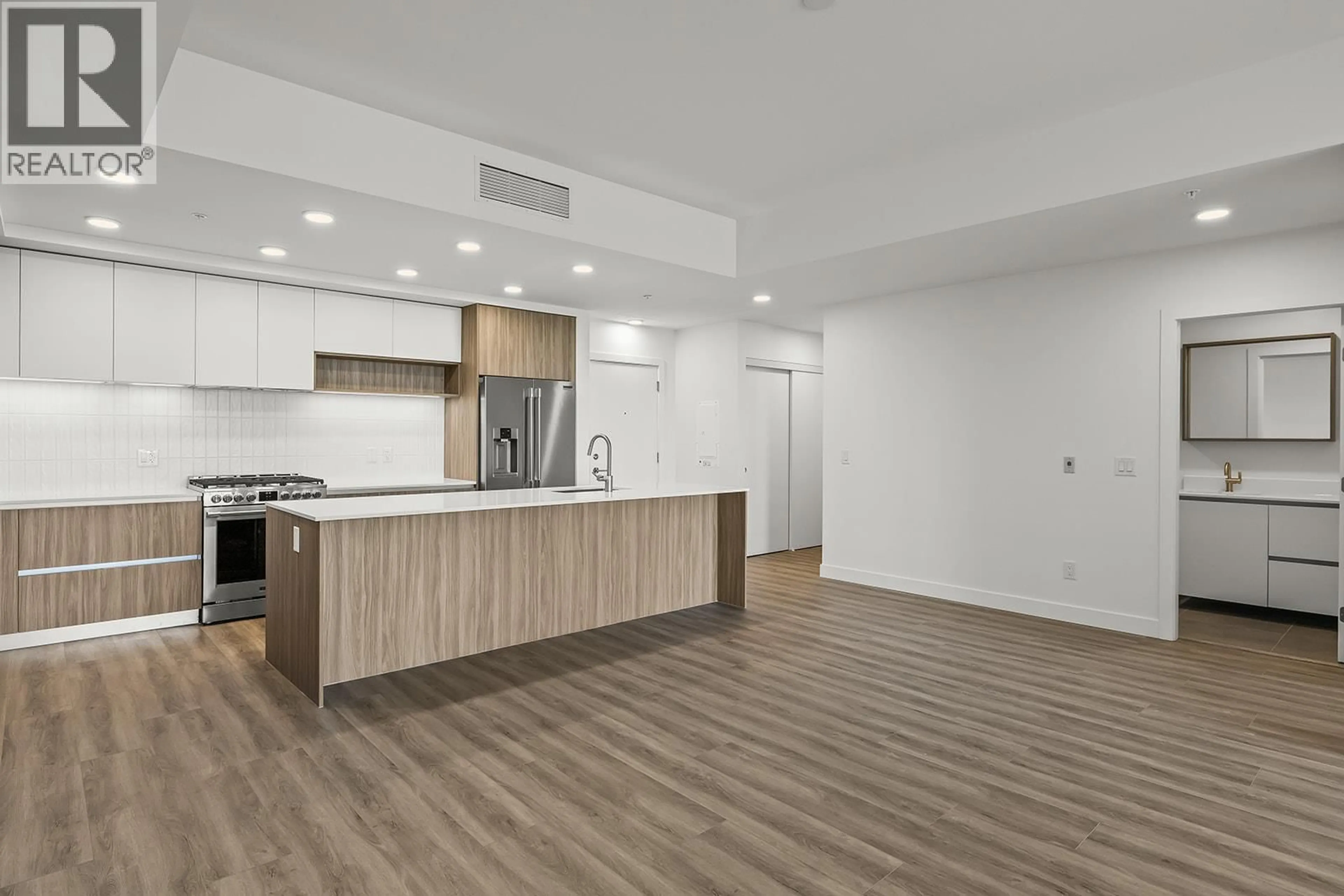 Open concept kitchen, wood/laminate floor for 107 - 2780 OLALLA ROAD, West Kelowna British Columbia V1Z2A9