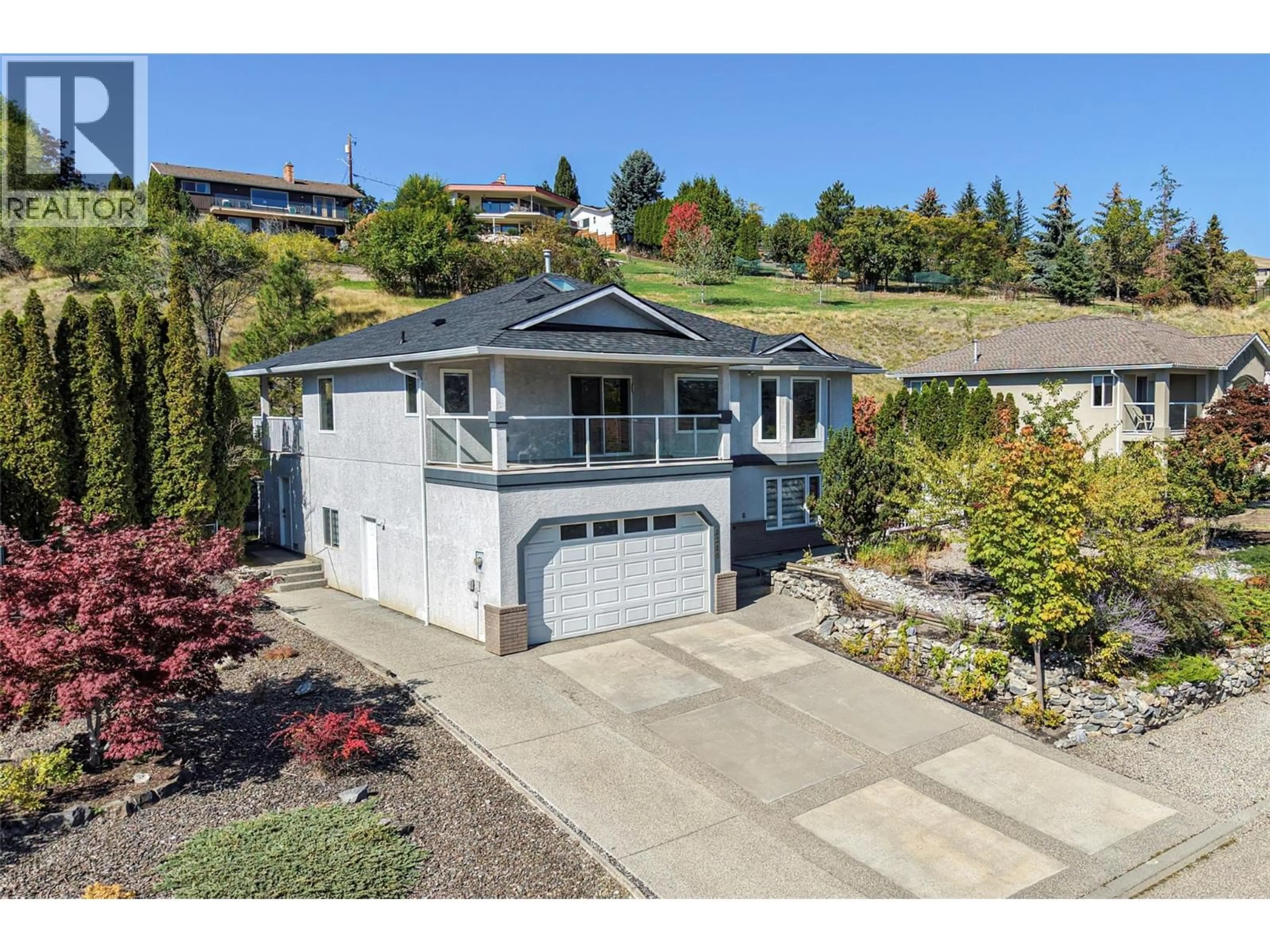 A pic from outside/outdoor area/front of a property/back of a property/a pic from drone, street for 8210 STONERIDGE DRIVE, Coldstream British Columbia V1B3M3
