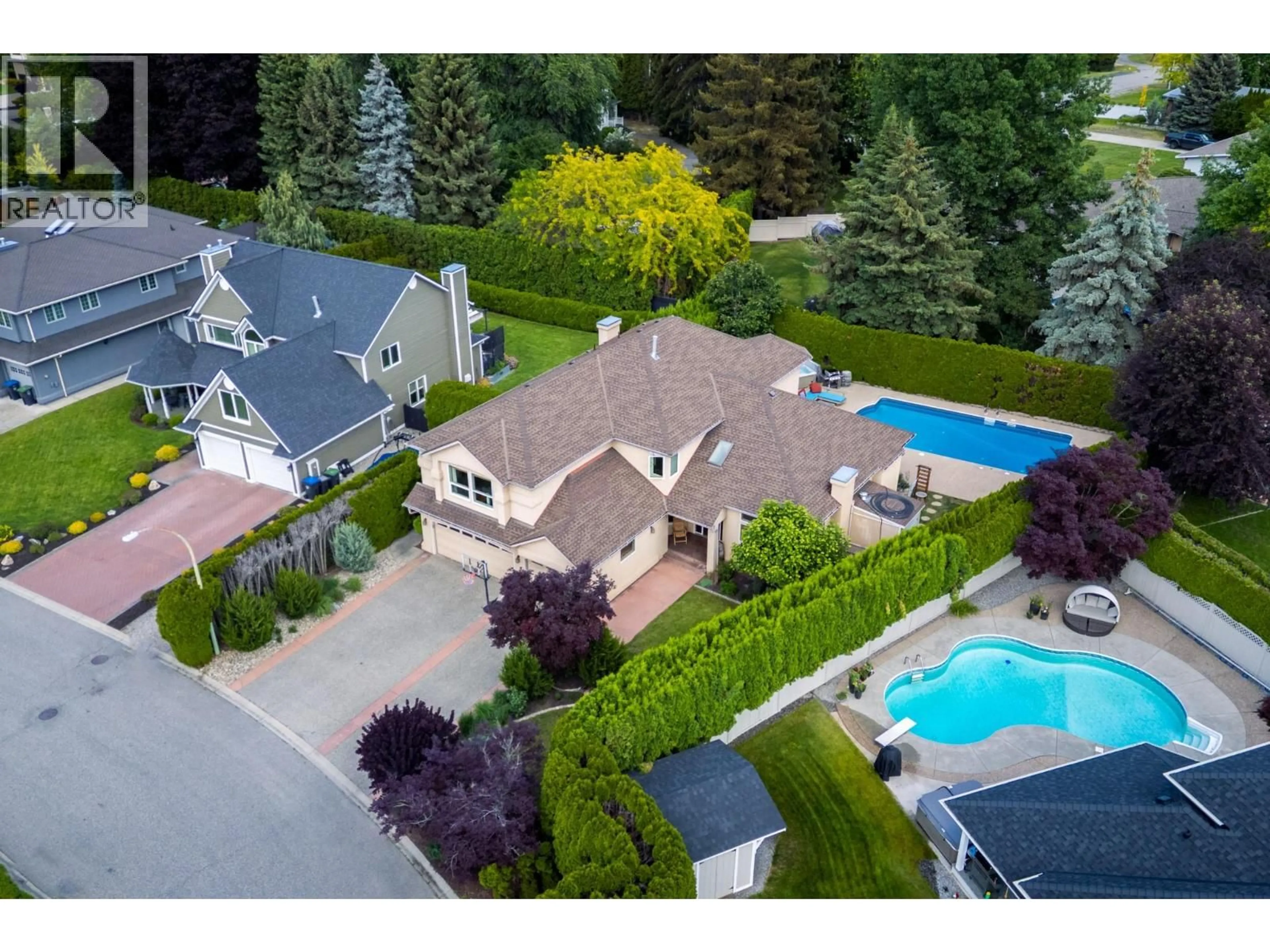 A pic from outside/outdoor area/front of a property/back of a property/a pic from drone, street for 492 CARONA CRESCENT, Kelowna British Columbia V1W3C6