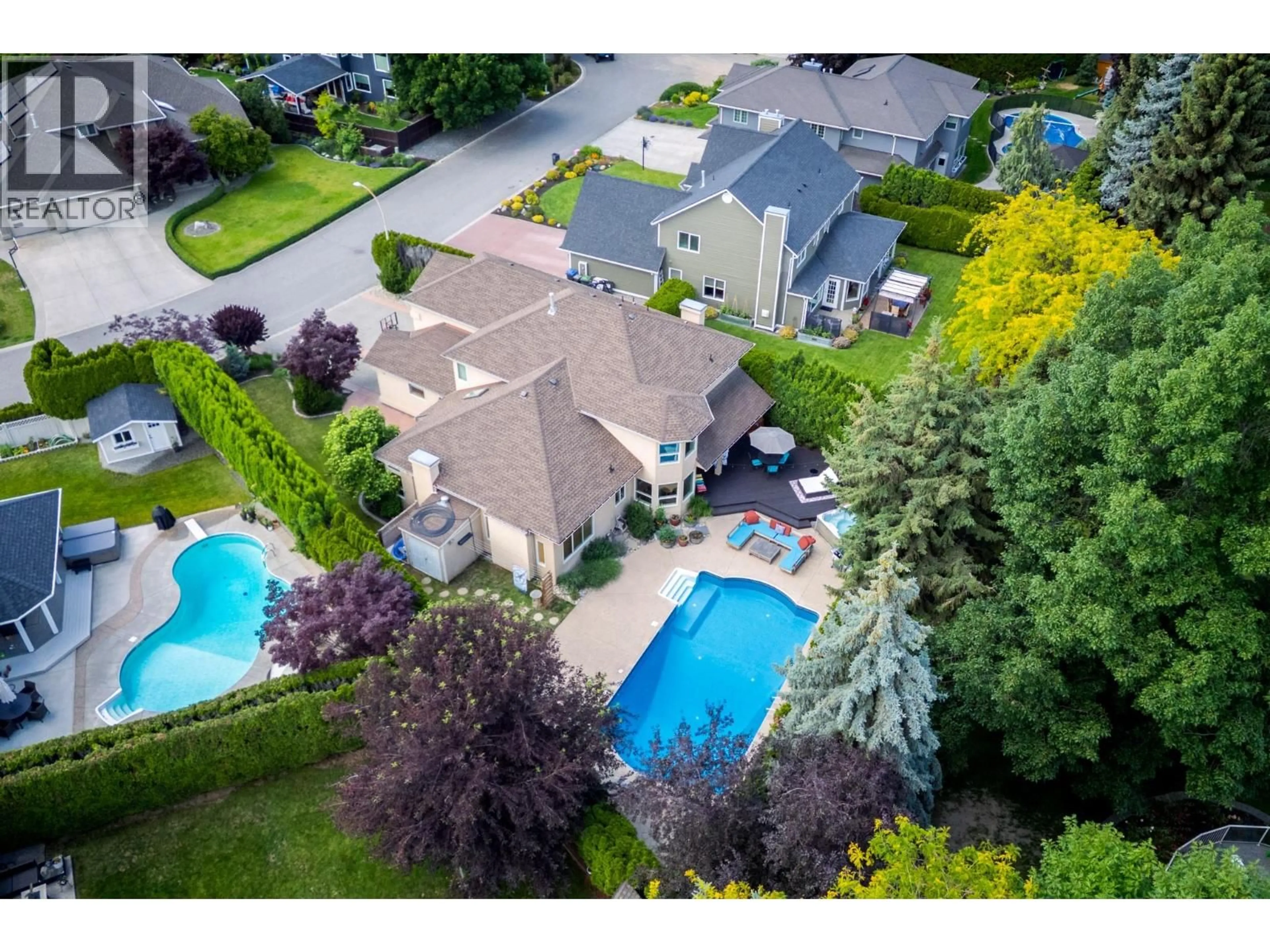 A pic from outside/outdoor area/front of a property/back of a property/a pic from drone, street for 492 CARONA CRESCENT, Kelowna British Columbia V1W3C6