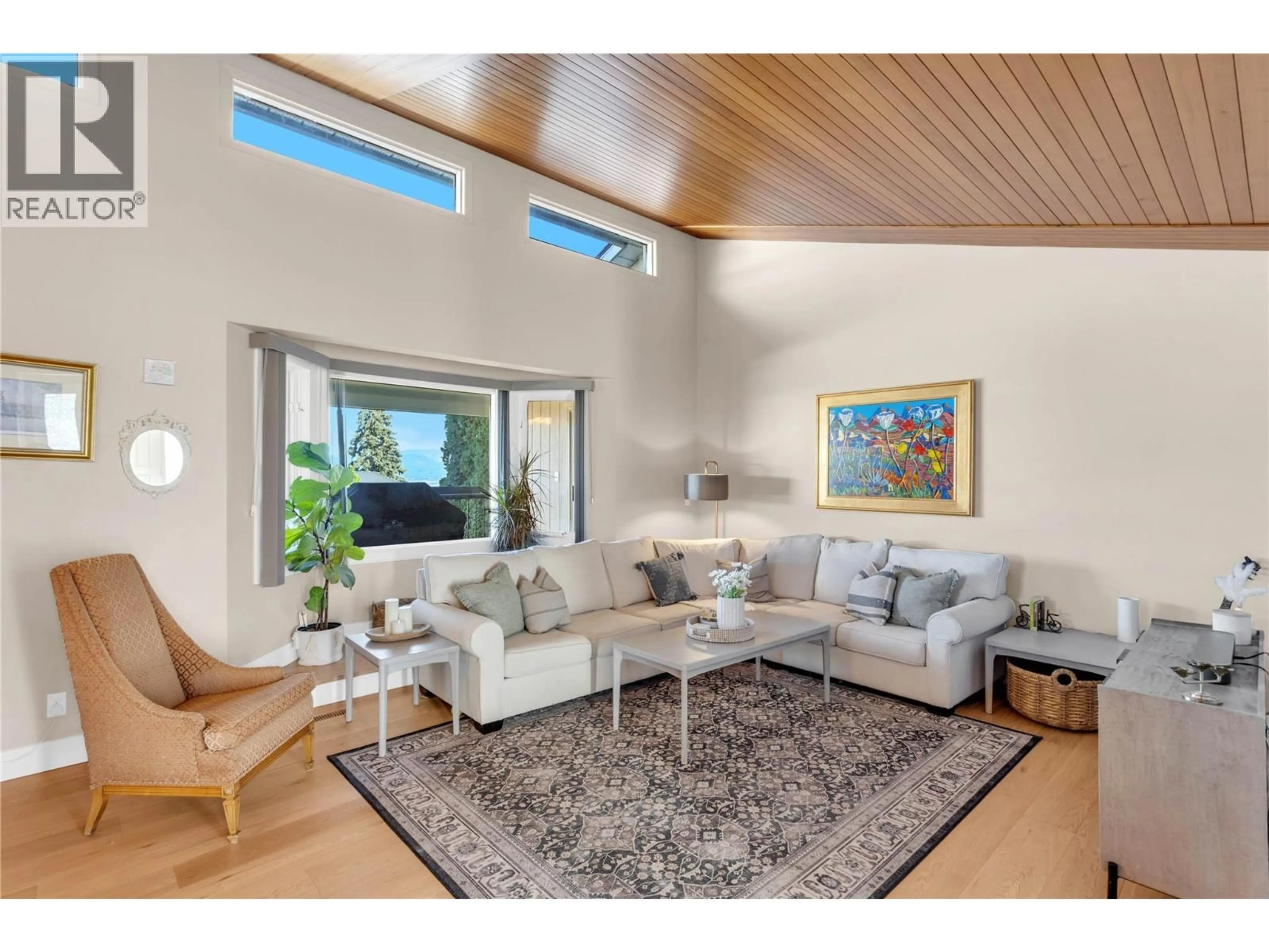 Living room with furniture, wood/laminate floor for 2245 THACKER DRIVE, West Kelowna British Columbia V1Z1V5