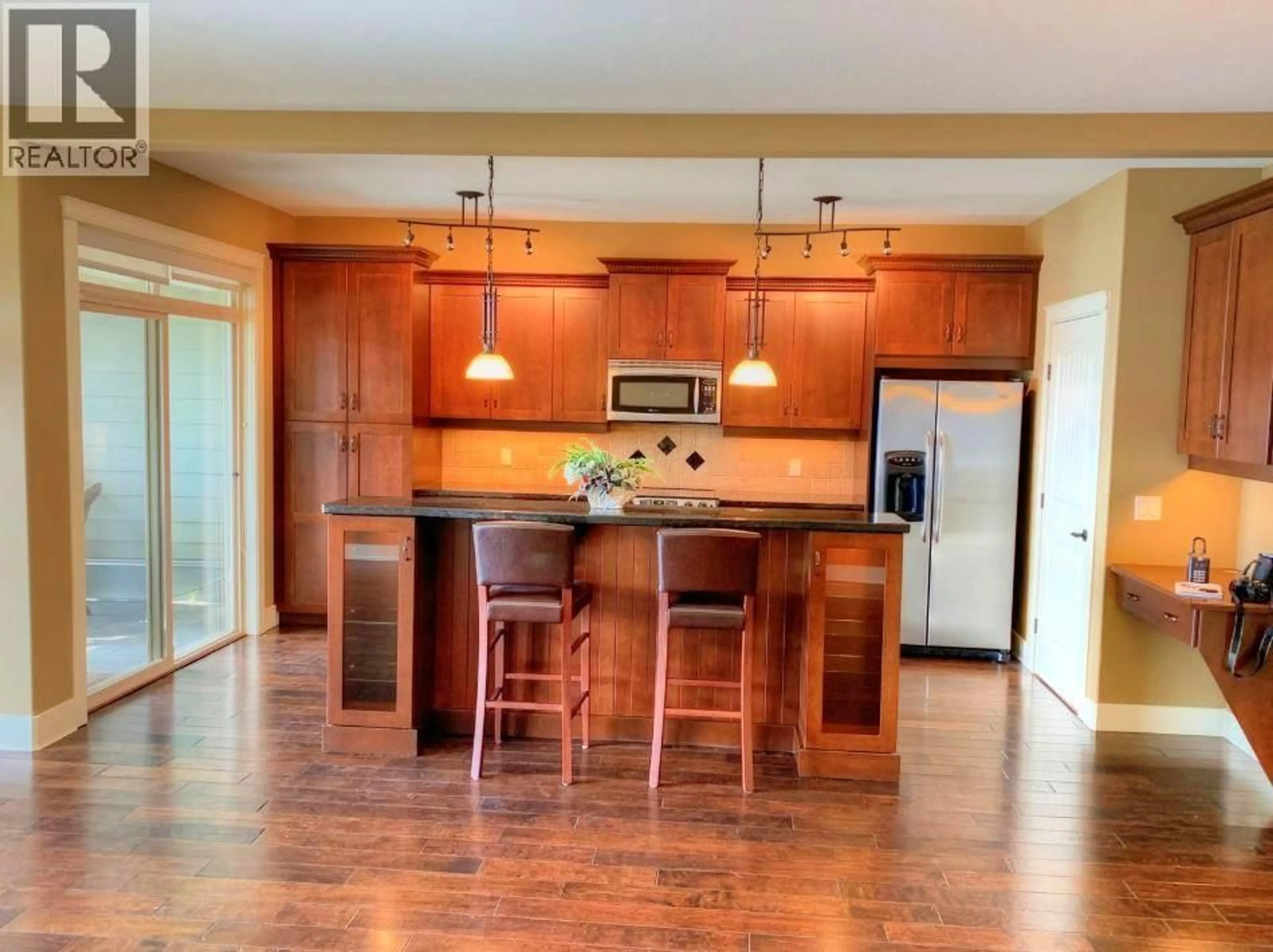 Open concept kitchen, wood/laminate floor for 113 - 4350 PONDEROSA DRIVE, Peachland British Columbia V0H1X5