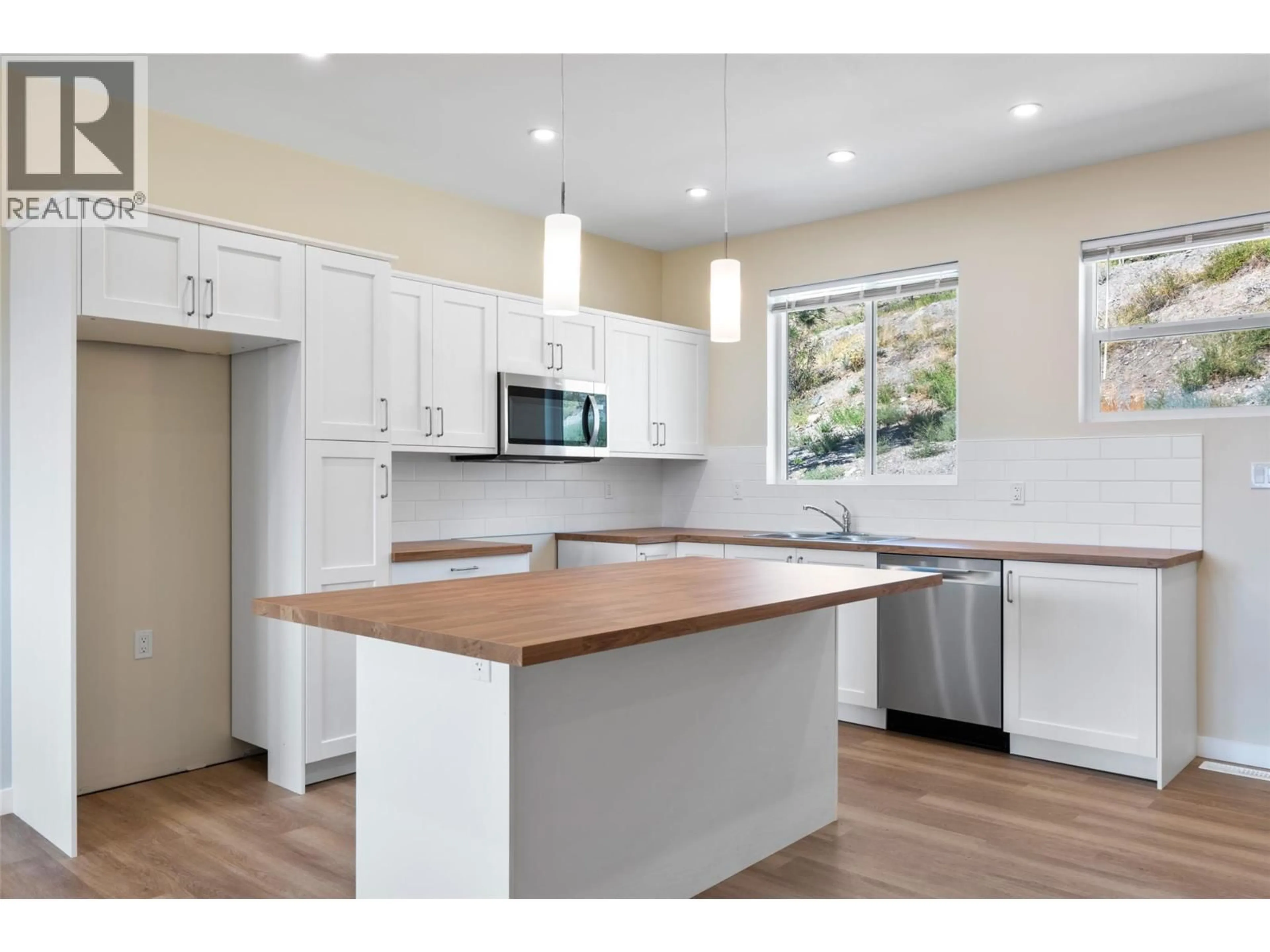 Open concept kitchen, wood/laminate floor for 2733 GRANDVIEW HEIGHTS, Merritt British Columbia V1K0A5