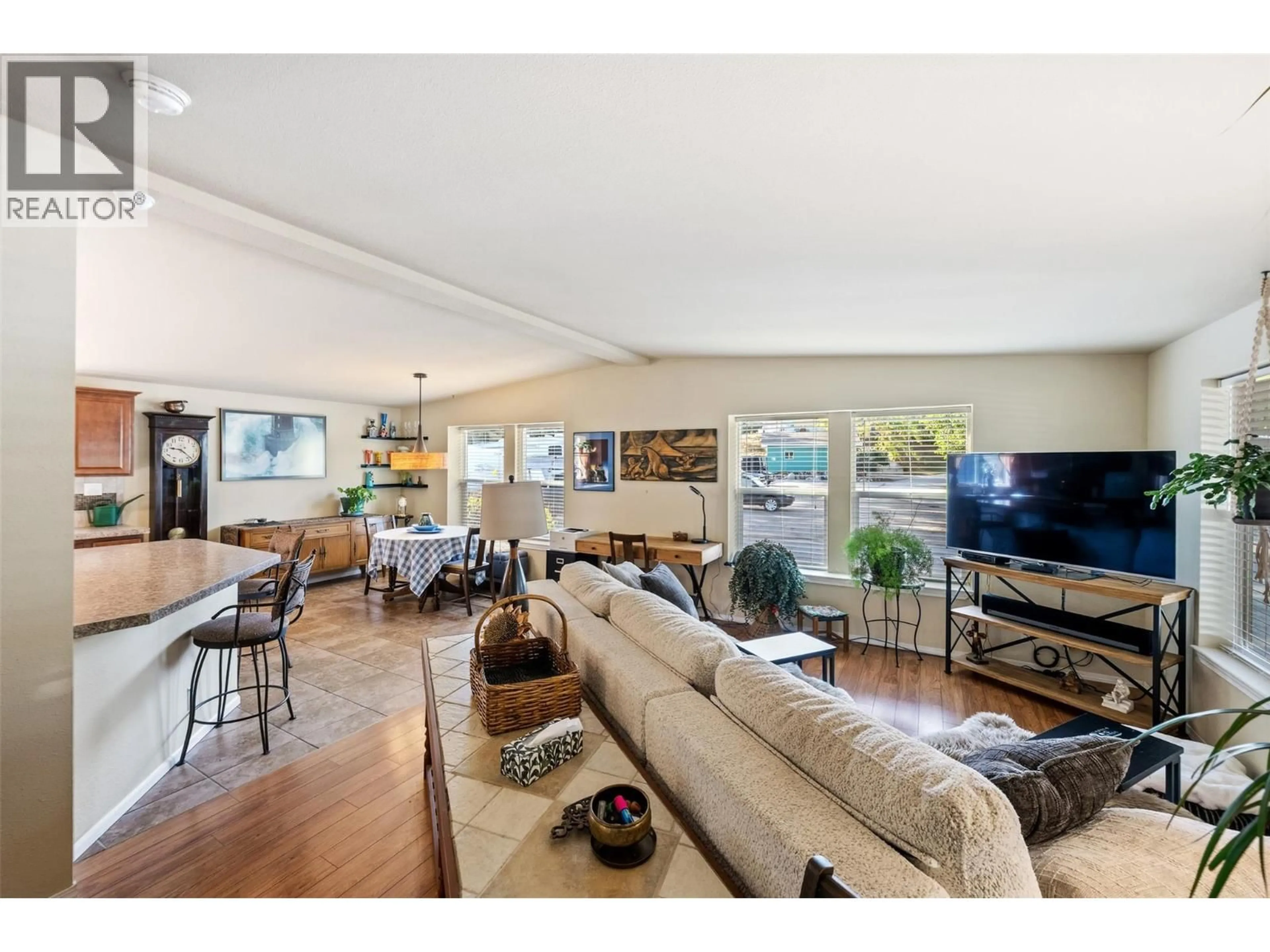 Living room with furniture, wood/laminate floor for 54 - 8712 STEUART STREET, Summerland British Columbia V0H1Z6