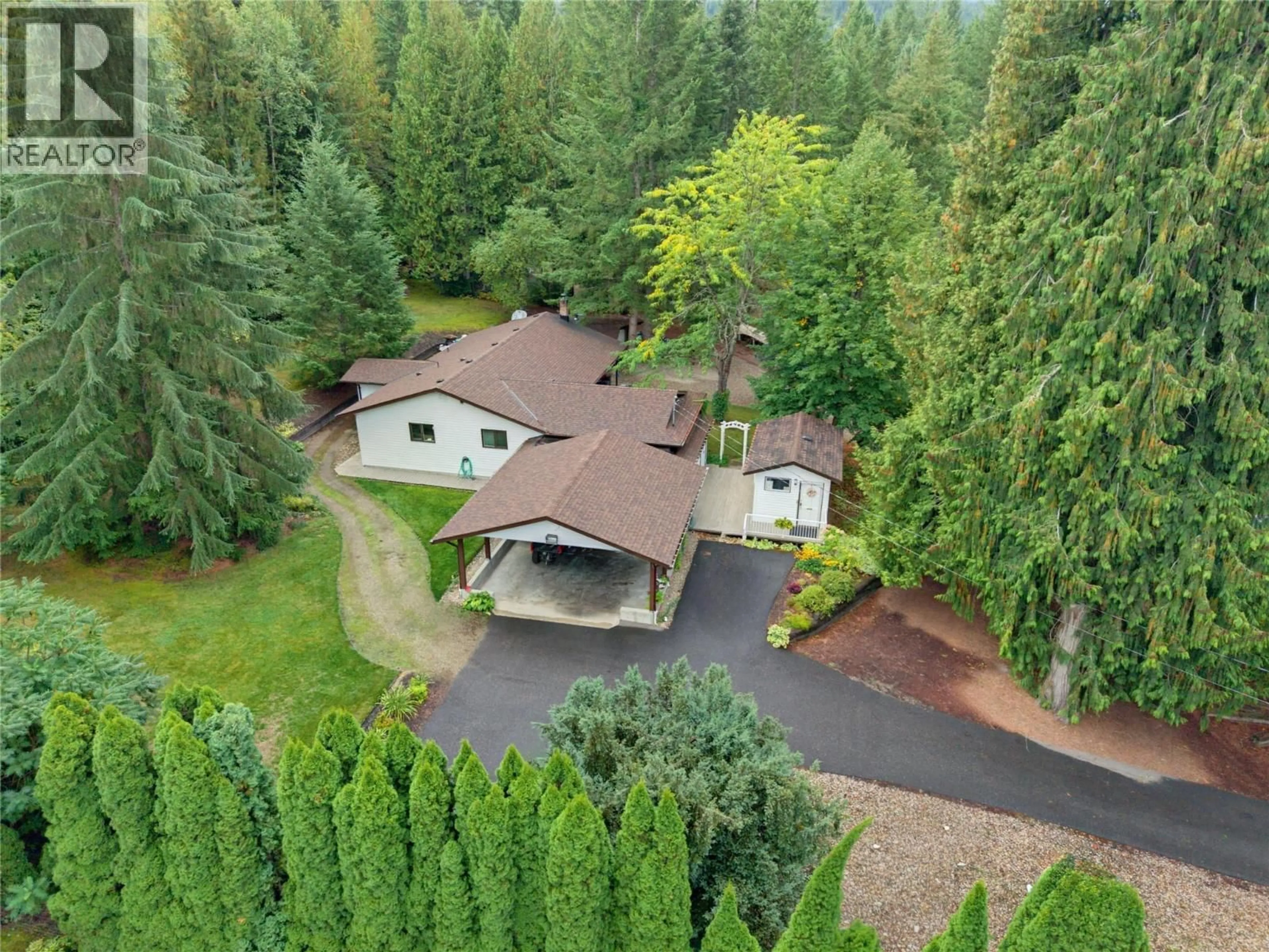 A pic from outside/outdoor area/front of a property/back of a property/a pic from drone, forest/trees view for 7787 97A HIGHWAY, Mara British Columbia V0E2K0