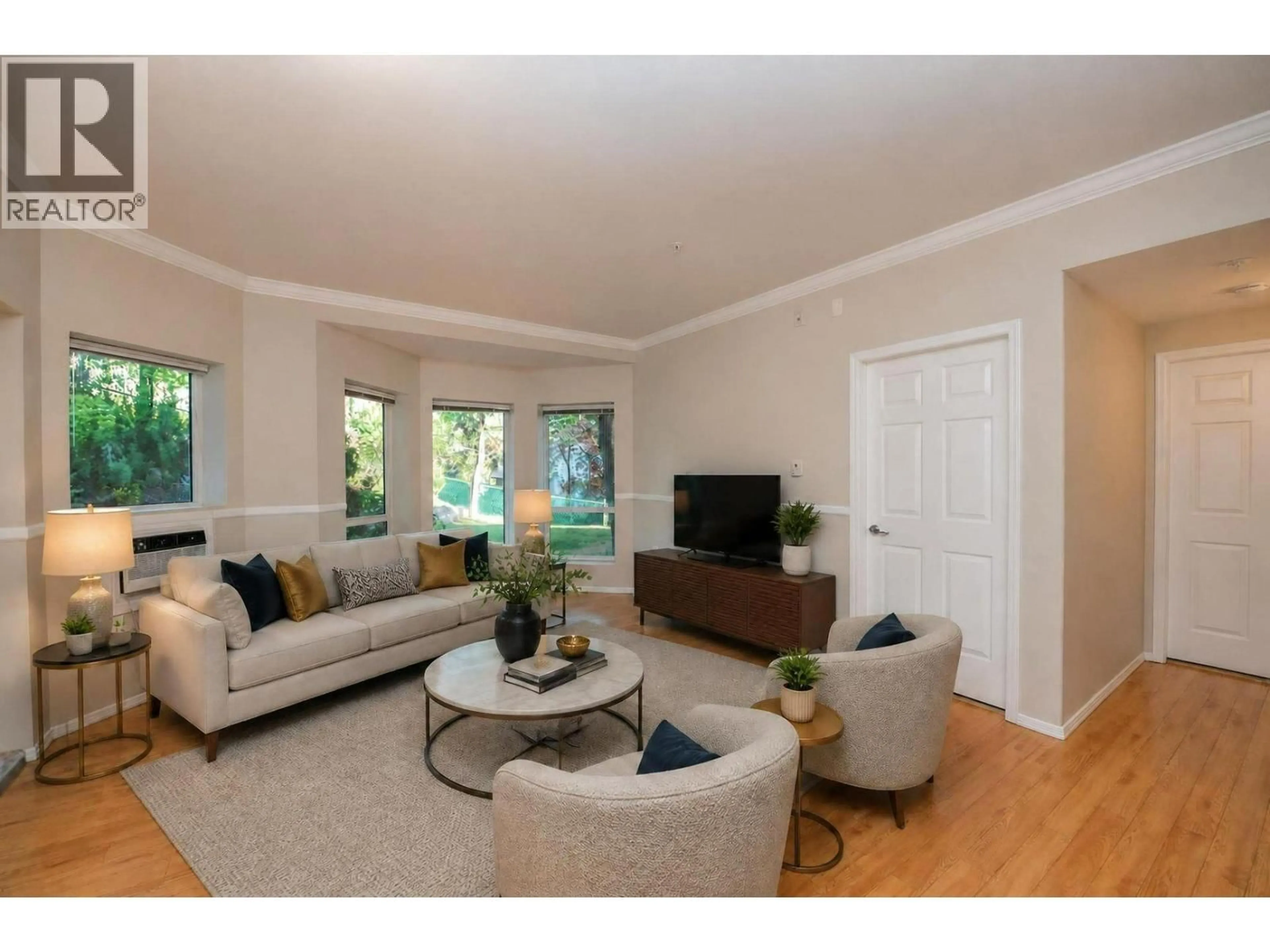 Living room with furniture, wood/laminate floor for 215 - 3011 GATEBY PLACE, Vernon British Columbia V1T9S4