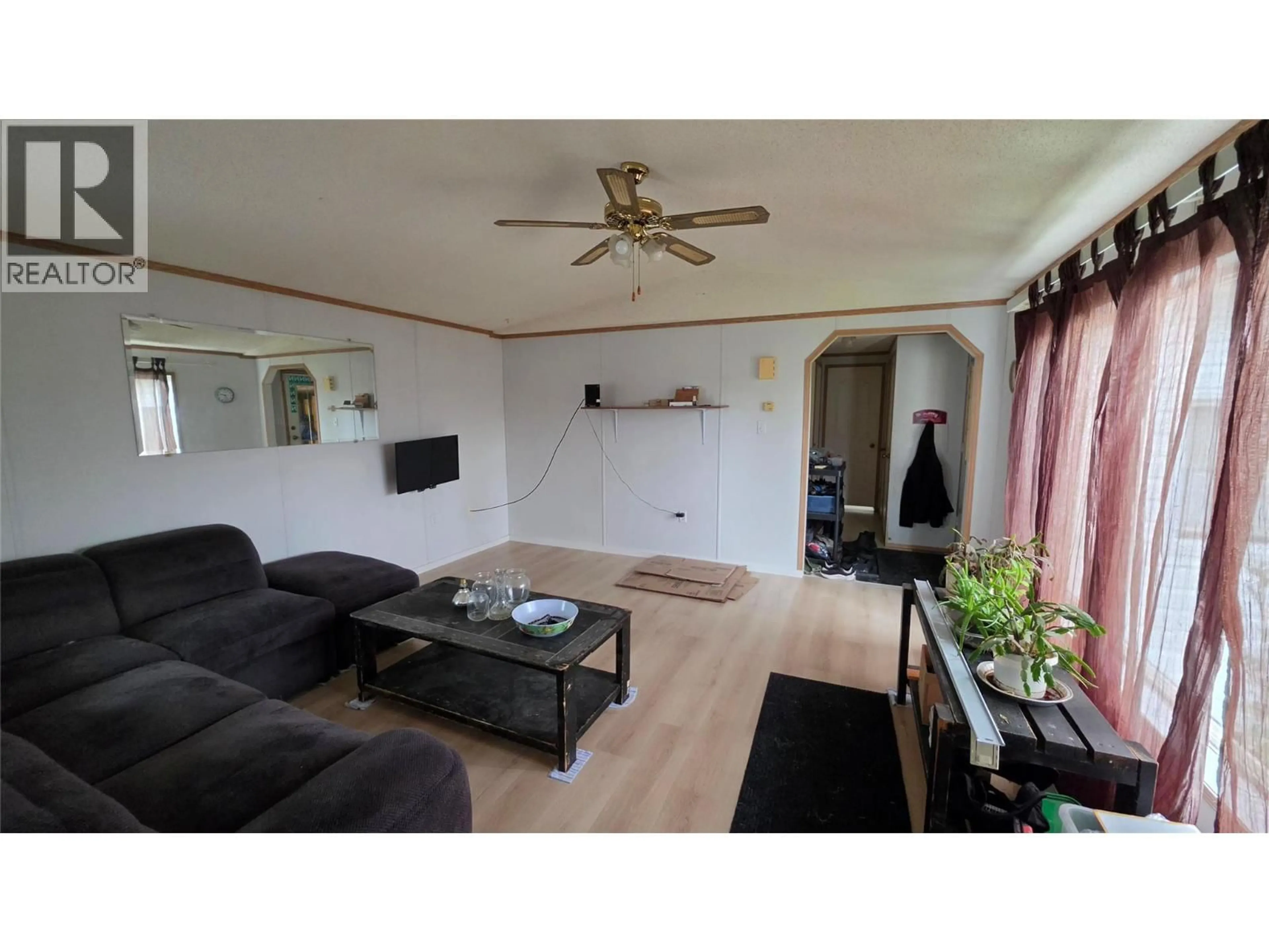 Living room with furniture, wood/laminate floor for 1201 118 AVENUE, Dawson Creek British Columbia V1G4L2