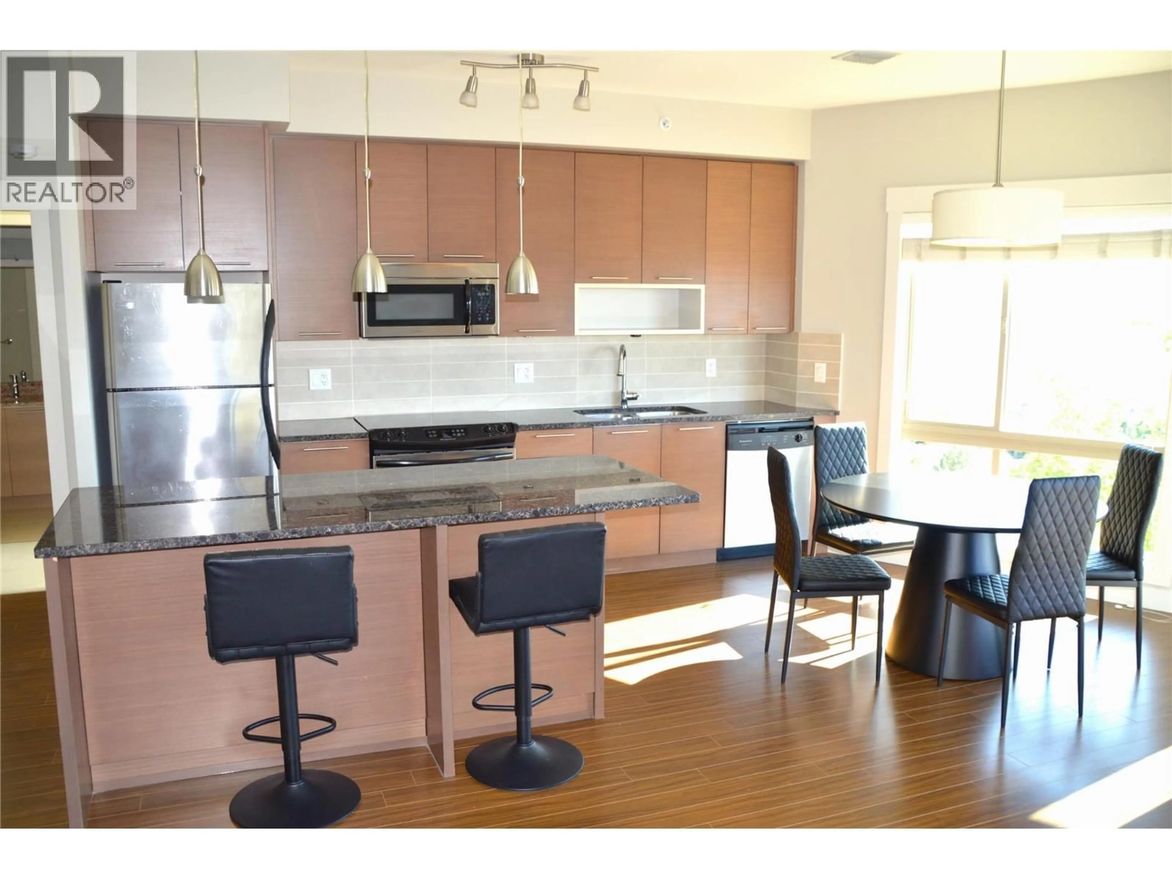 Open concept kitchen, wood/laminate floor for 1403-1000 TALASA WAY, Kamloops British Columbia V2H0C2