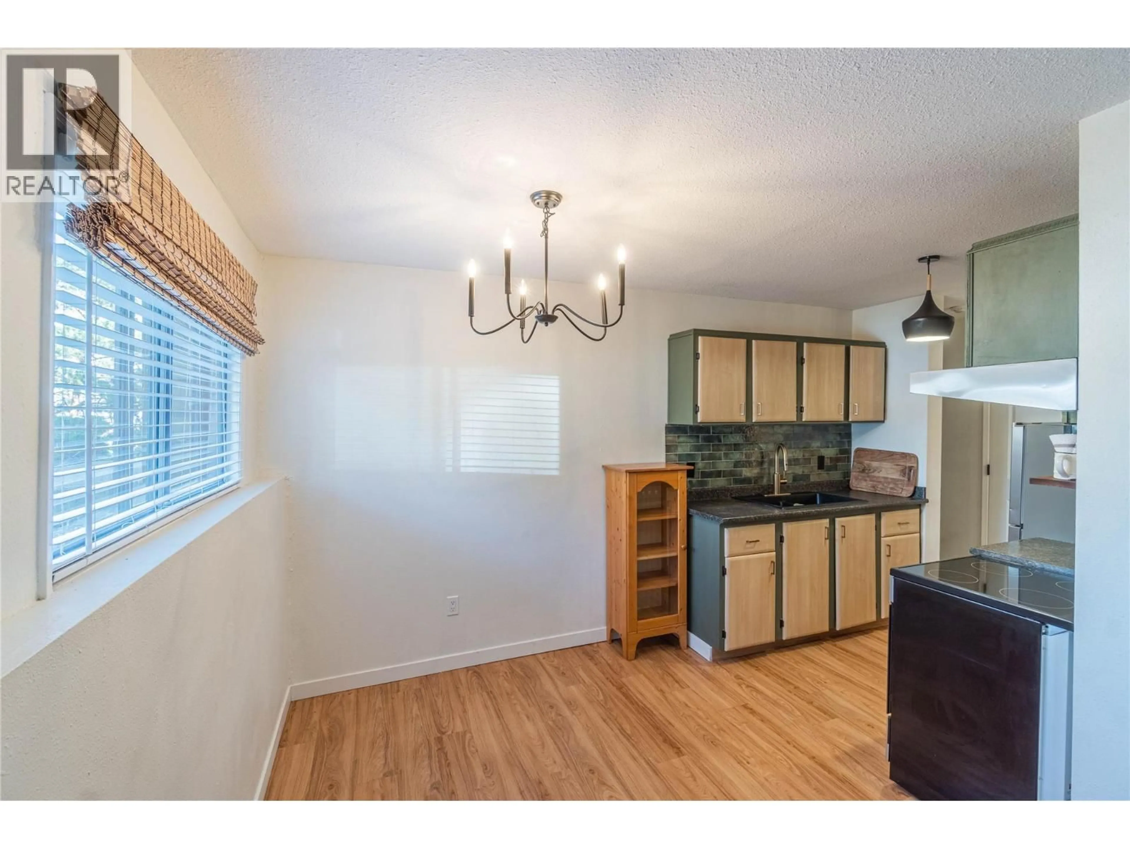 Open concept kitchen, wood/laminate floor for 106 - 555 DALGLEISH DRIVE, Kamloops British Columbia V2C6C7