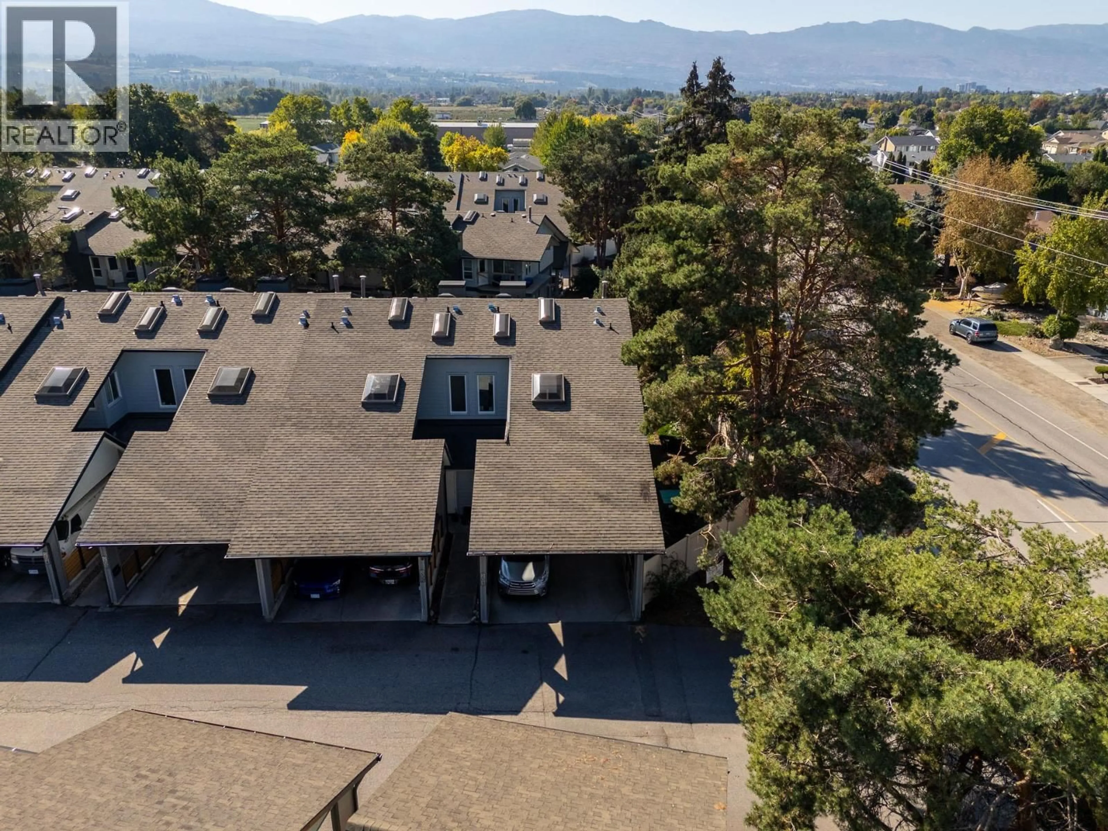 A pic from outside/outdoor area/front of a property/back of a property/a pic from drone, mountain view for 201 - 2125 BURTCH ROAD, Kelowna British Columbia V1Y8N1