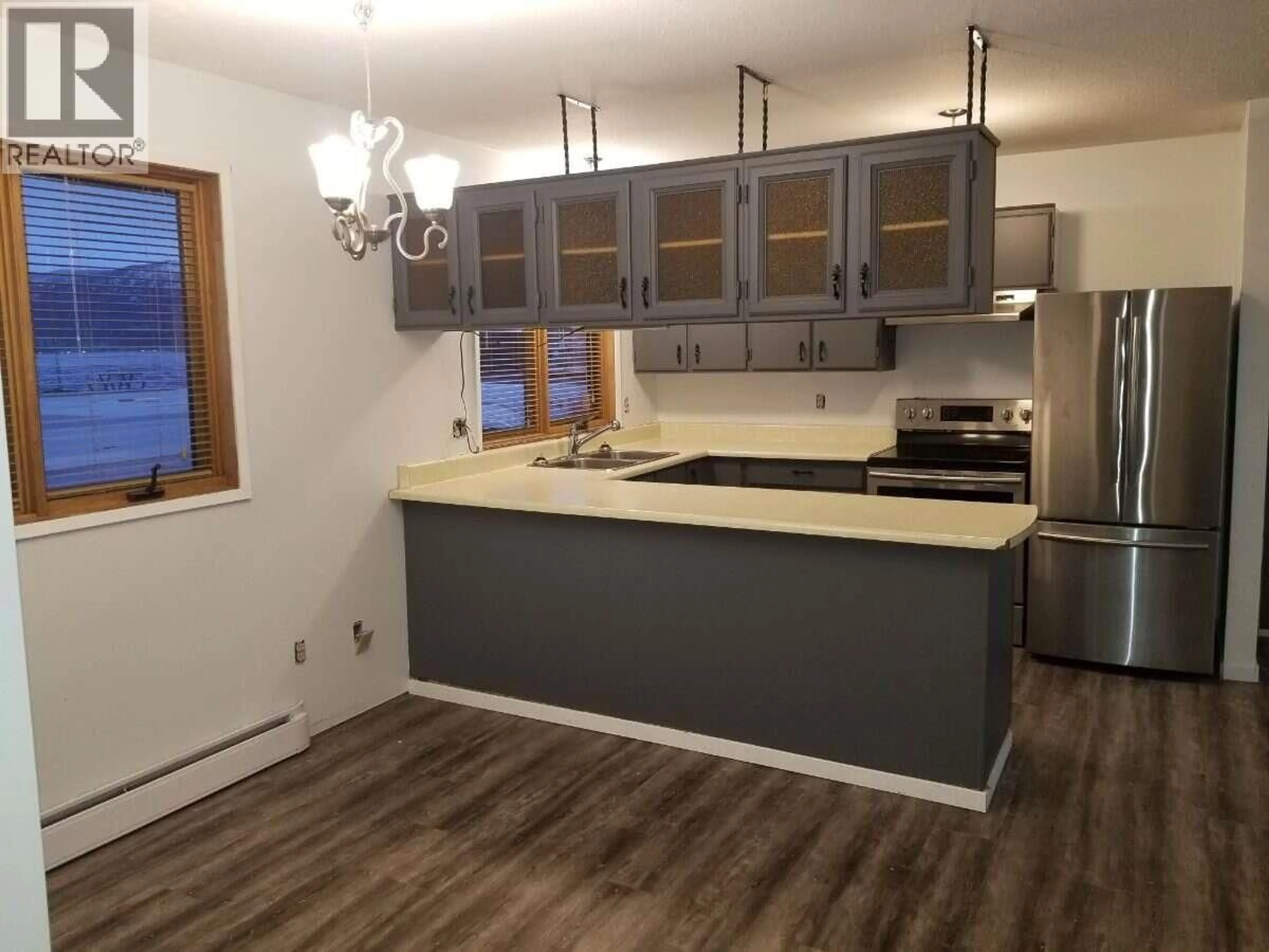 Open concept kitchen, wood/laminate floor for 4194 BEACH AVENUE, Peachland British Columbia V0H1X6