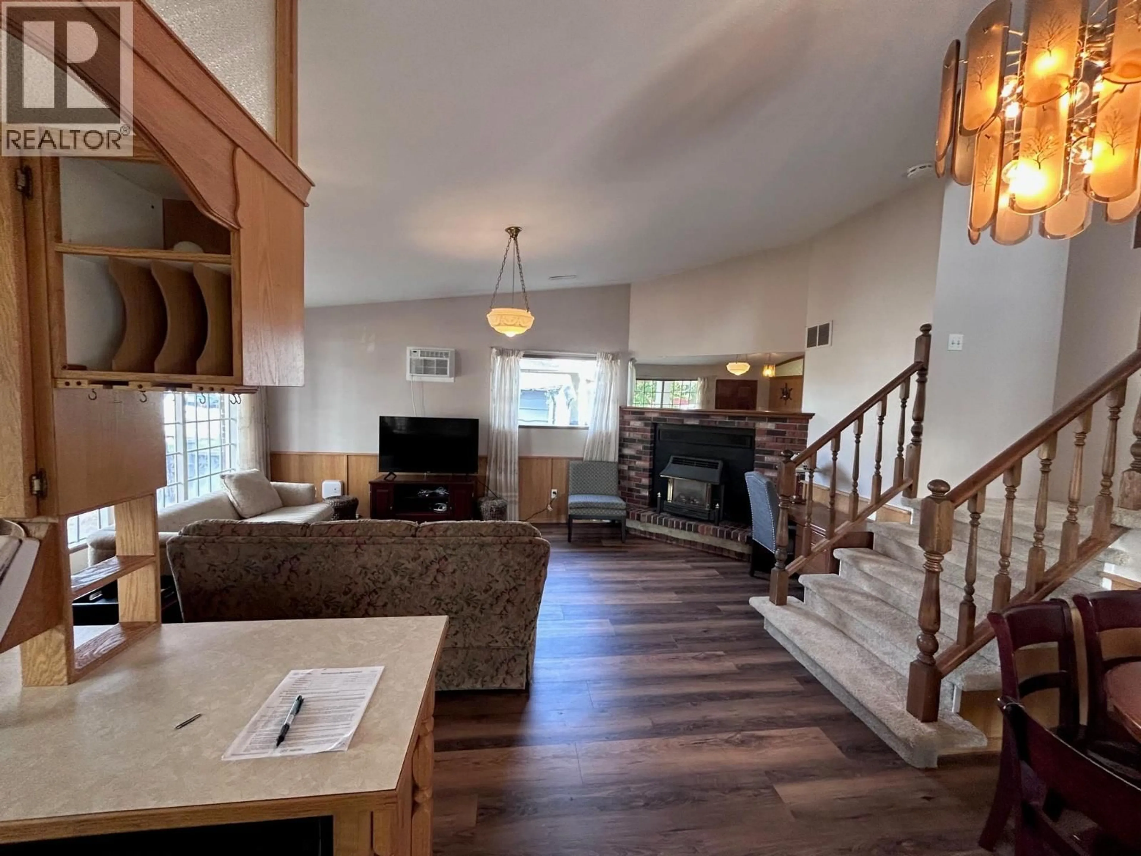 Living room with furniture, wood/laminate floor for 255 CAMBIE ROAD, Kelowna British Columbia V1X3H9