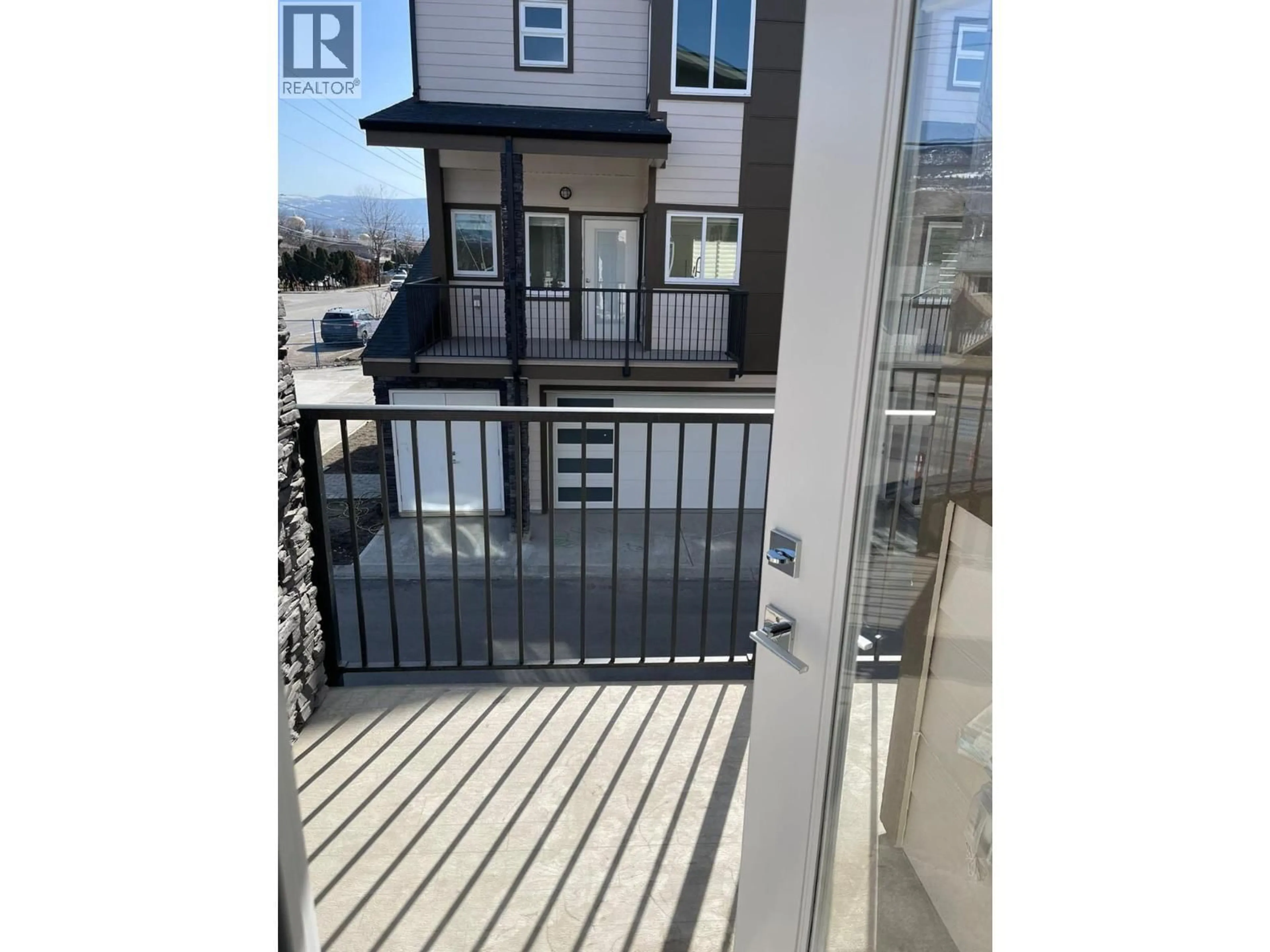 Balcony in the apartment, city buildings view from balcony for 1 - 1354 RUTLAND ROAD NORTH, Kelowna British Columbia V1X0C2
