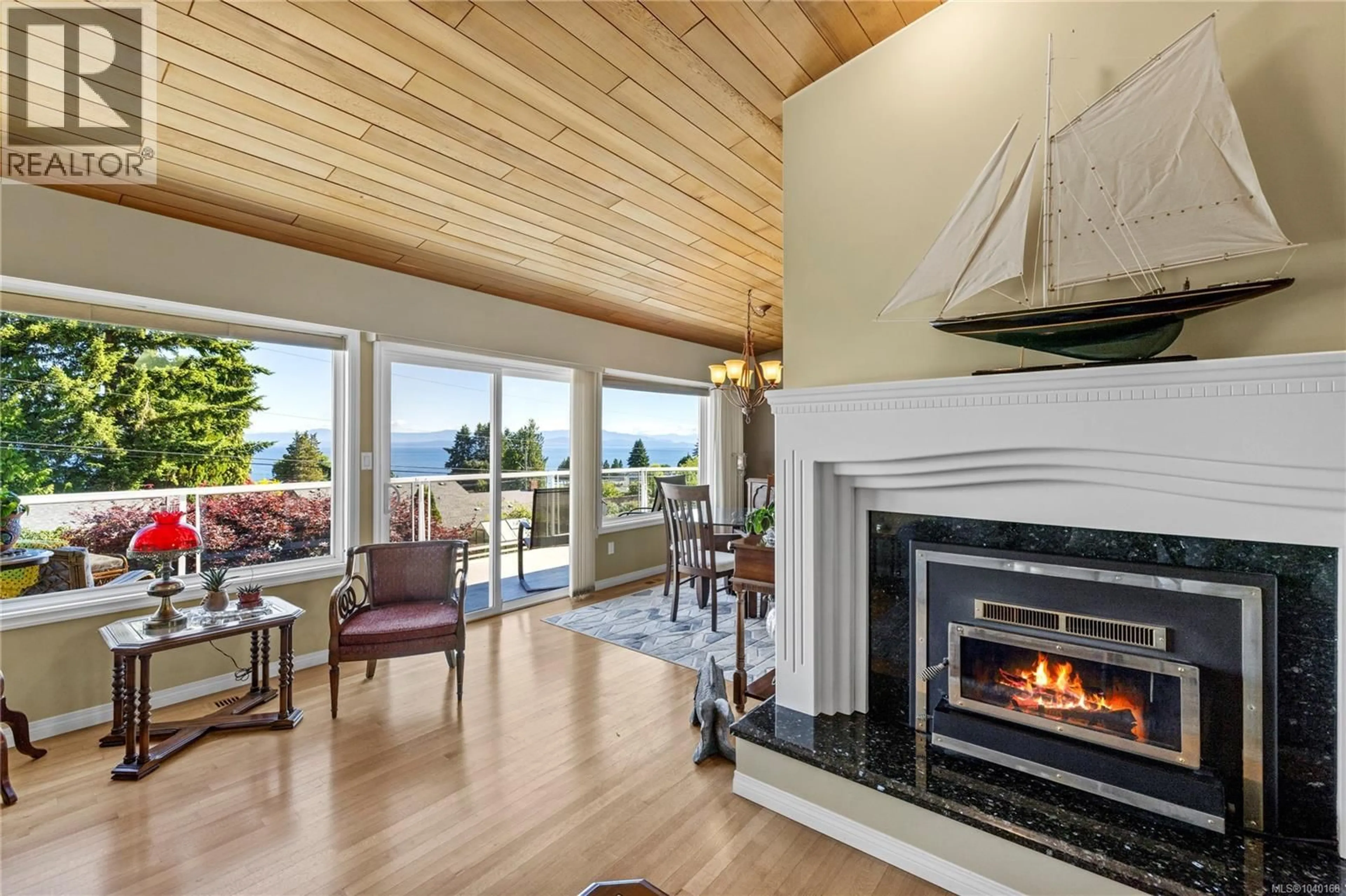 Living room with furniture, wood/laminate floor for 323 HOYLAKE ROAD WEST, Qualicum Beach British Columbia V9K1K5
