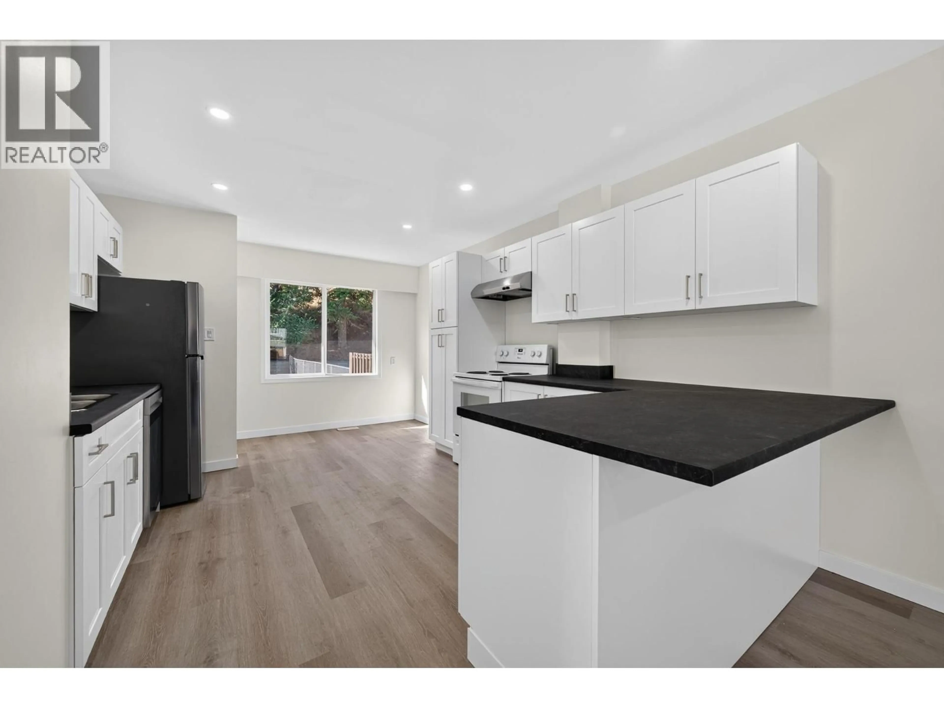 Open concept kitchen, wood/laminate floor for 2257/2259 VALLEYVIEW DRIVE, Kamloops British Columbia V2C4C8