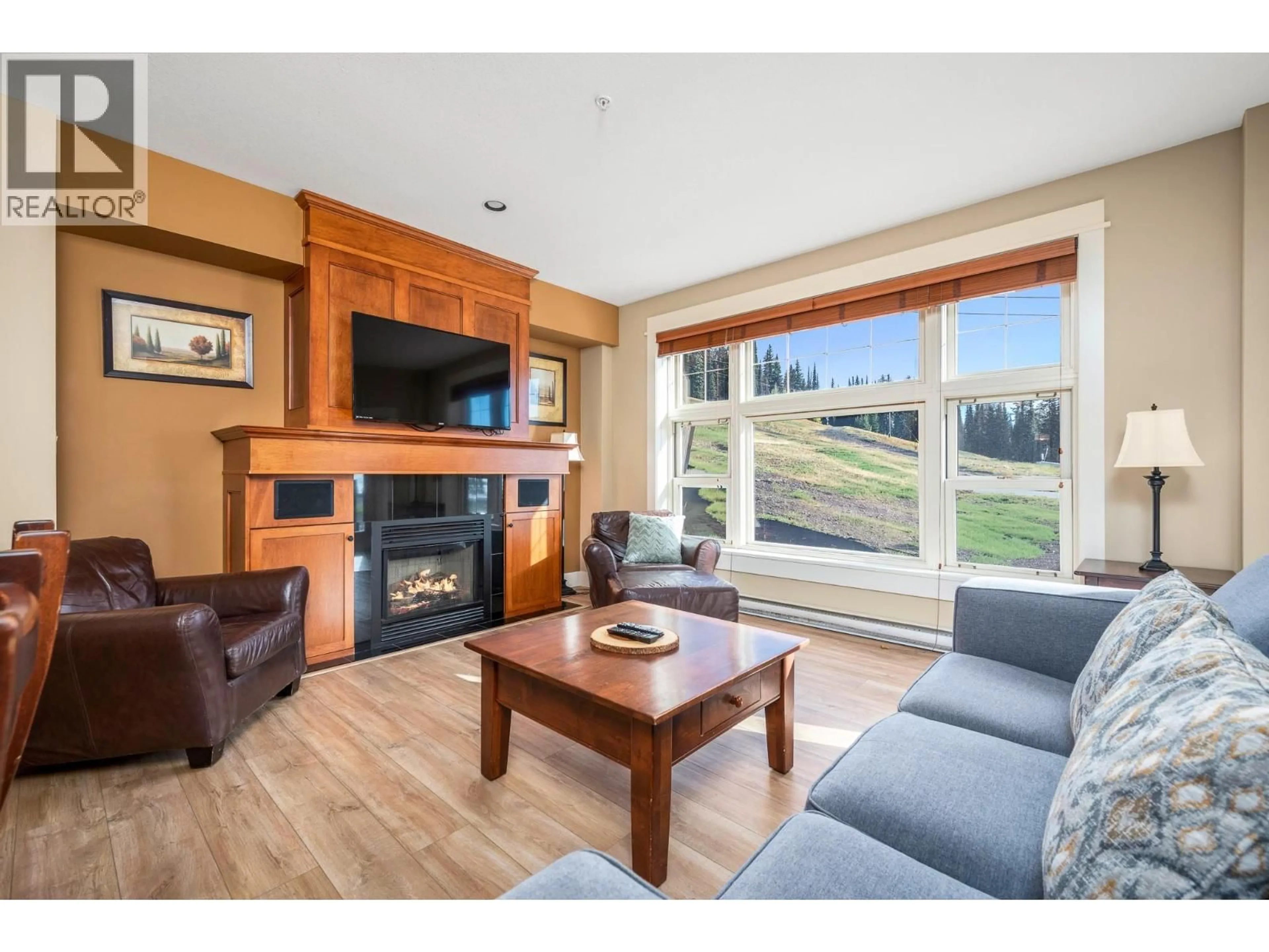 Living room with furniture, wood/laminate floor for 105 - 170 SILVER LODE LANE LANE, Silver Star British Columbia V1B3M1