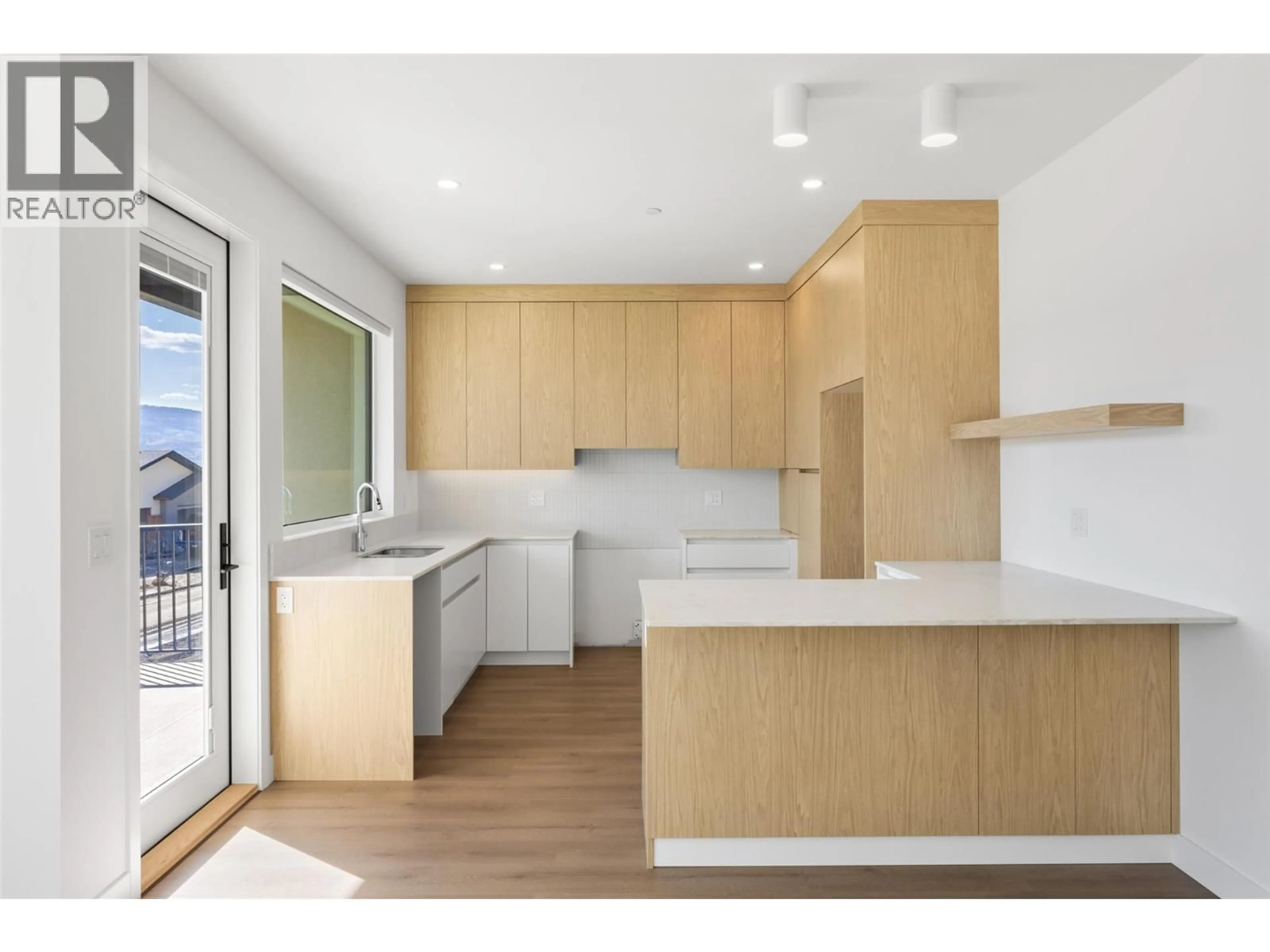 Open concept kitchen, wood/laminate floor for 5044 SUN RIVERS DRIVE, Kamloops British Columbia V2H0E7