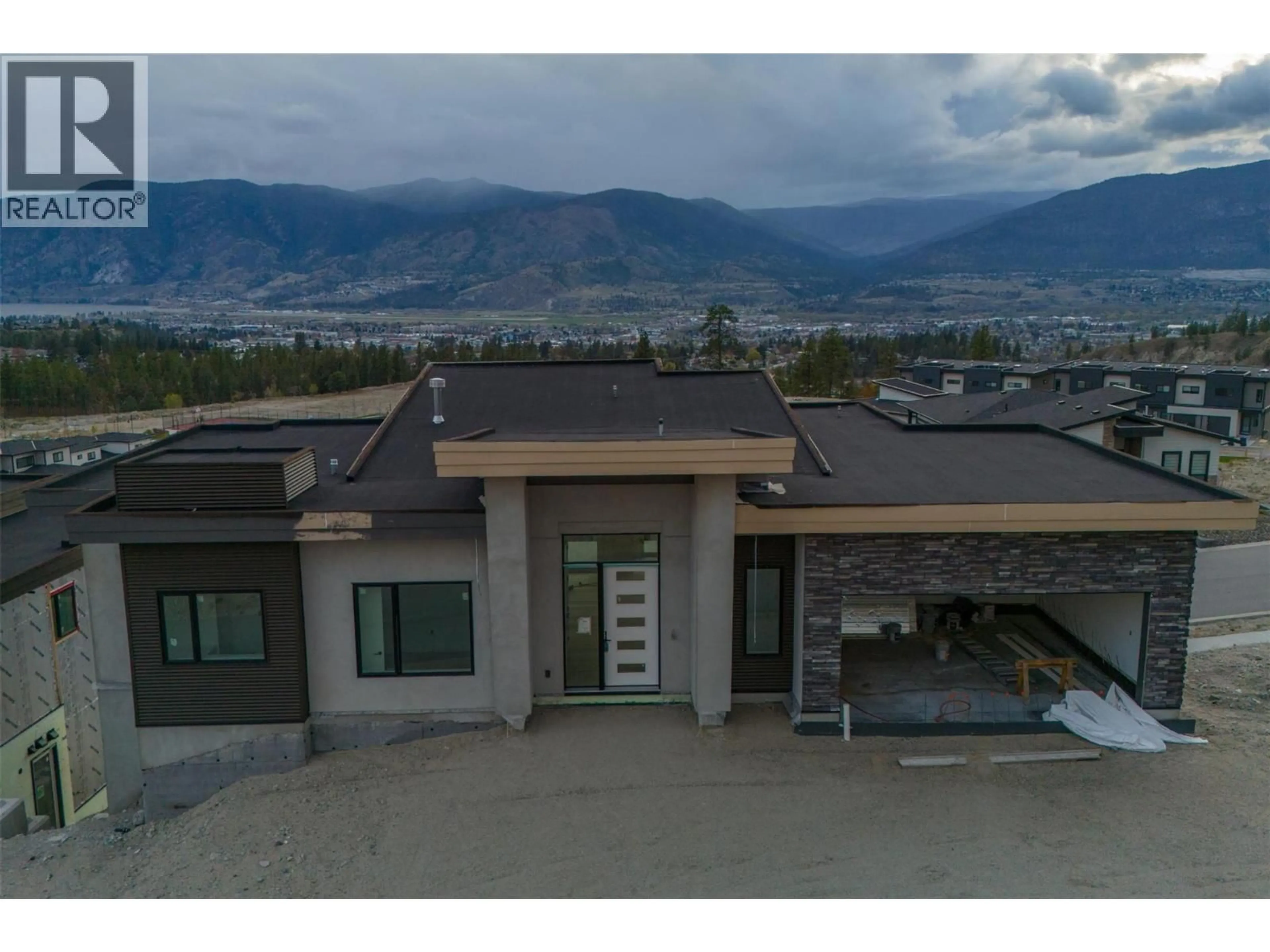 A pic from outside/outdoor area/front of a property/back of a property/a pic from drone, mountain view for 1092 ANTLER DRIVE, Penticton British Columbia V2A0J8