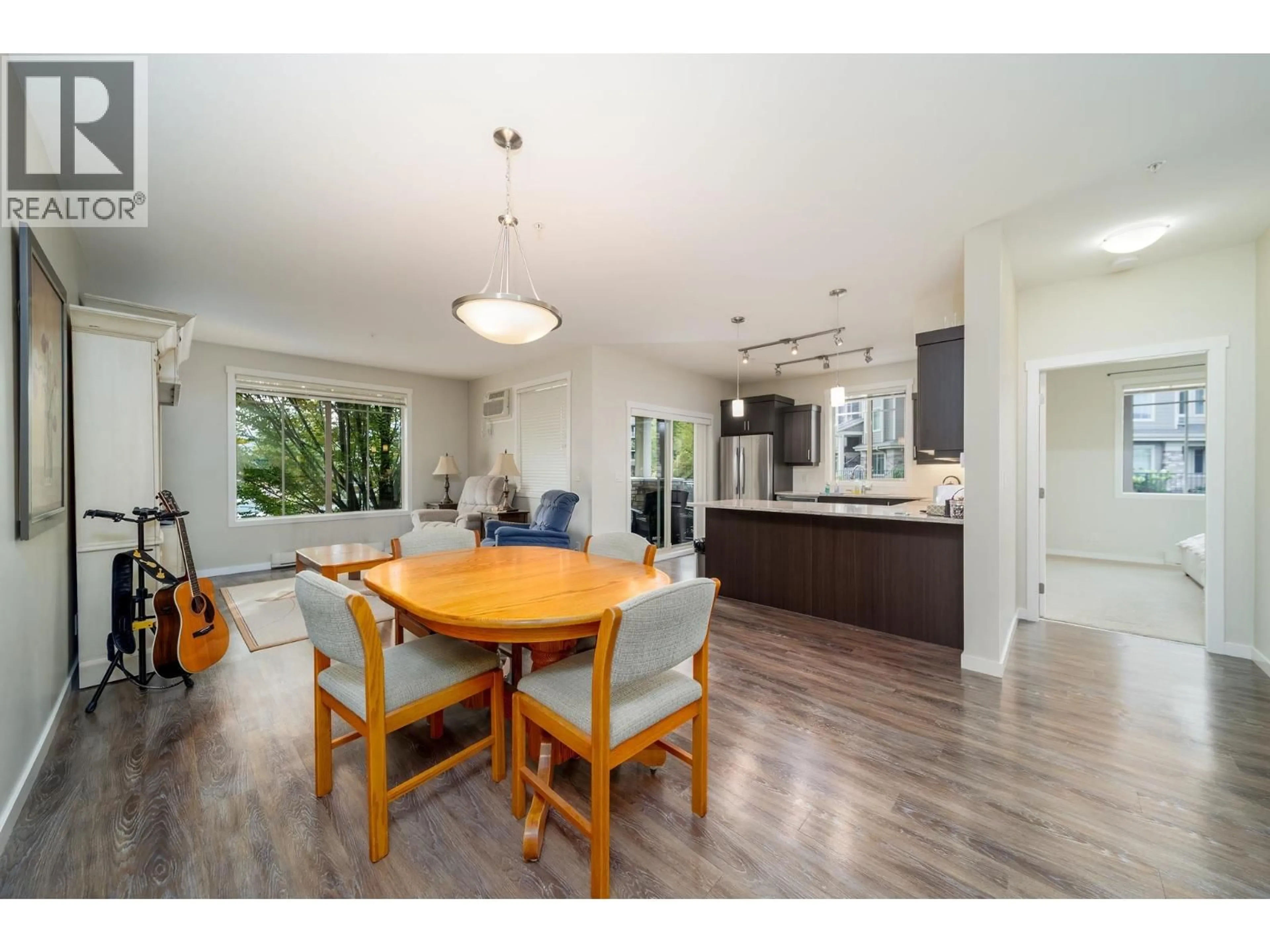 Open concept kitchen, wood/laminate floor for 104 - 3733 CASORSO ROAD, Kelowna British Columbia V1W5E3