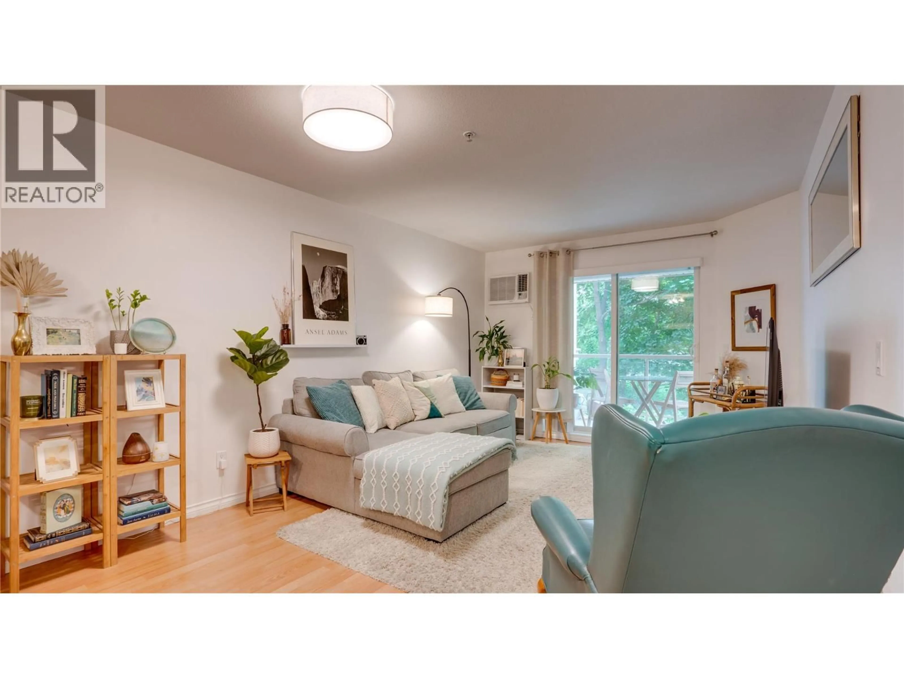 Living room with furniture, wood/laminate floor for 105 - 1965 PANDOSY STREET, Kelowna British Columbia V1Y1R9