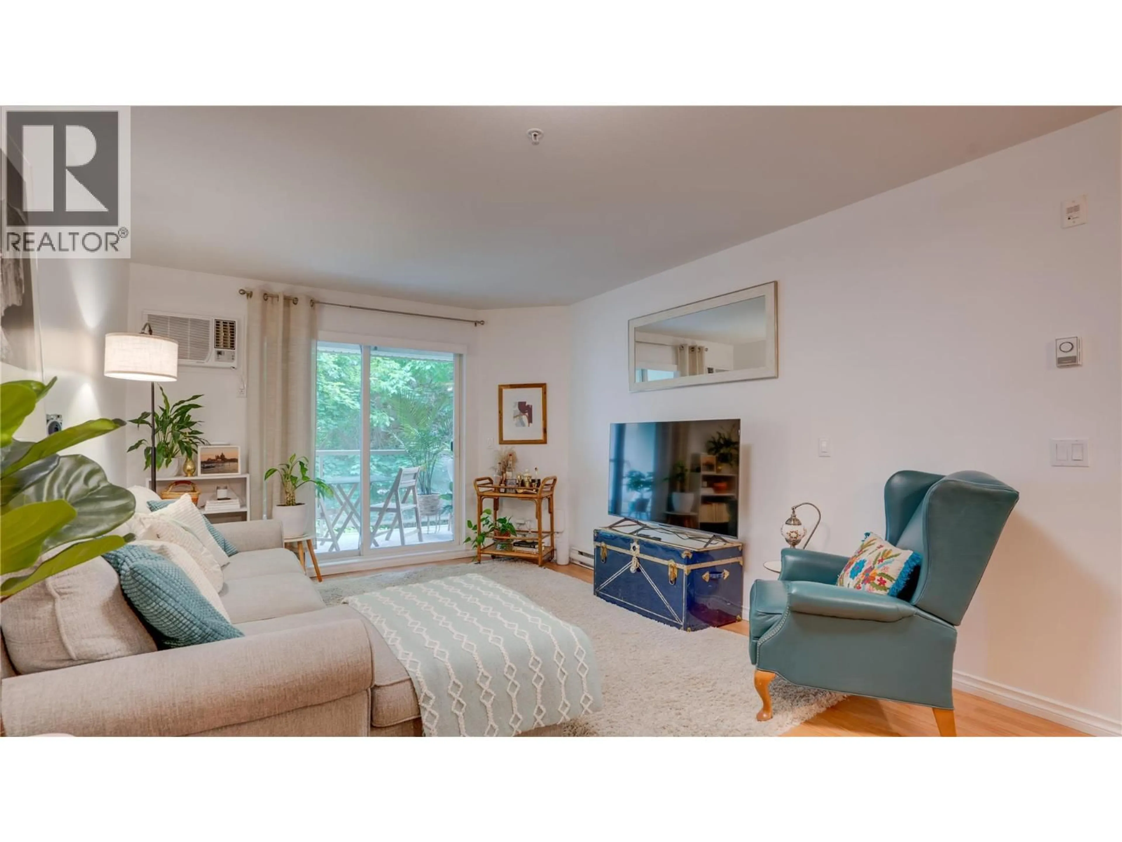 Living room with furniture, wood/laminate floor for 105 - 1965 PANDOSY STREET, Kelowna British Columbia V1Y1R9