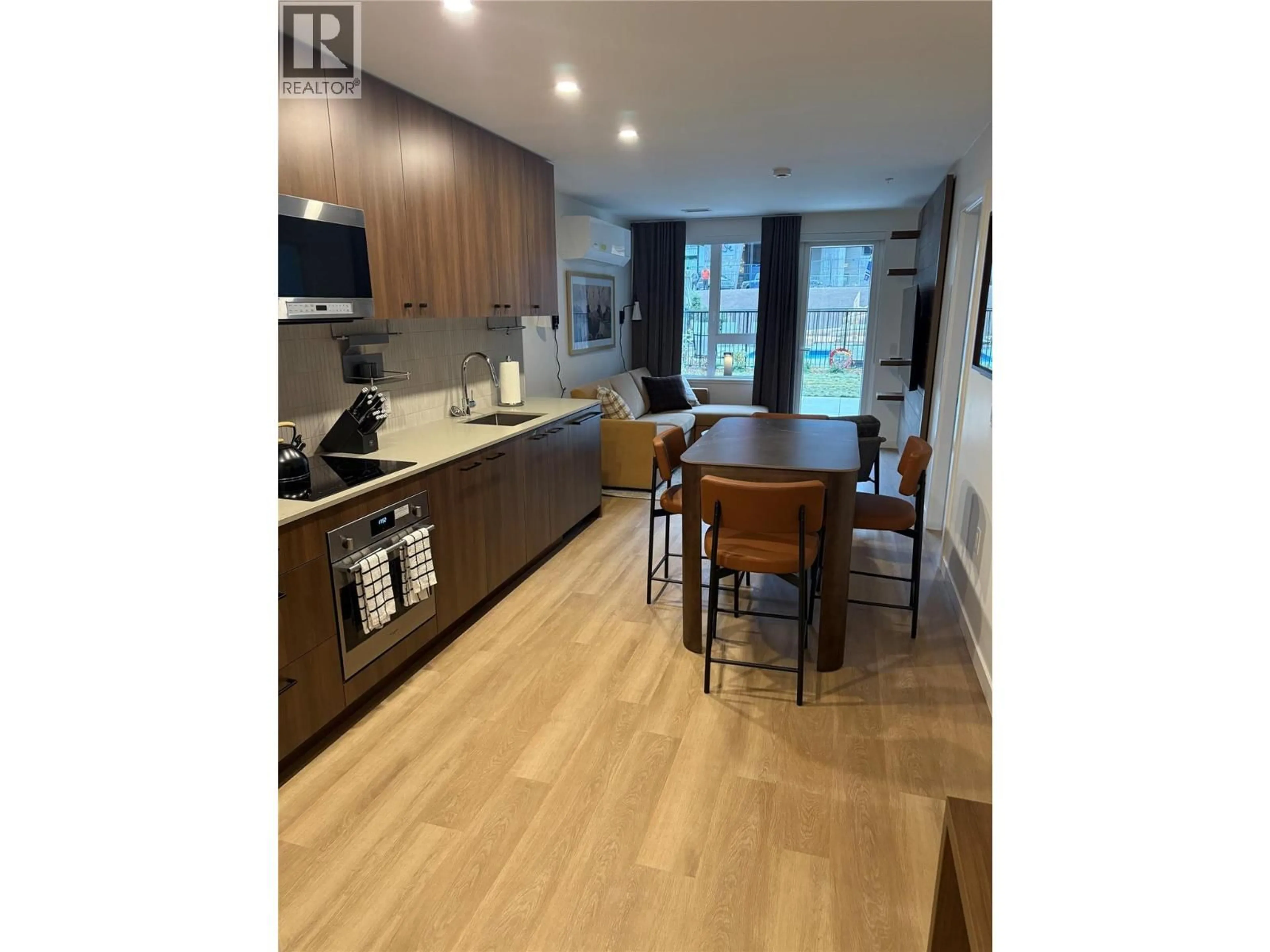 Open concept kitchen, wood/laminate floor for 203 - 4240 RED MOUNTAIN ROAD STREET, Rossland British Columbia V0G1Y0