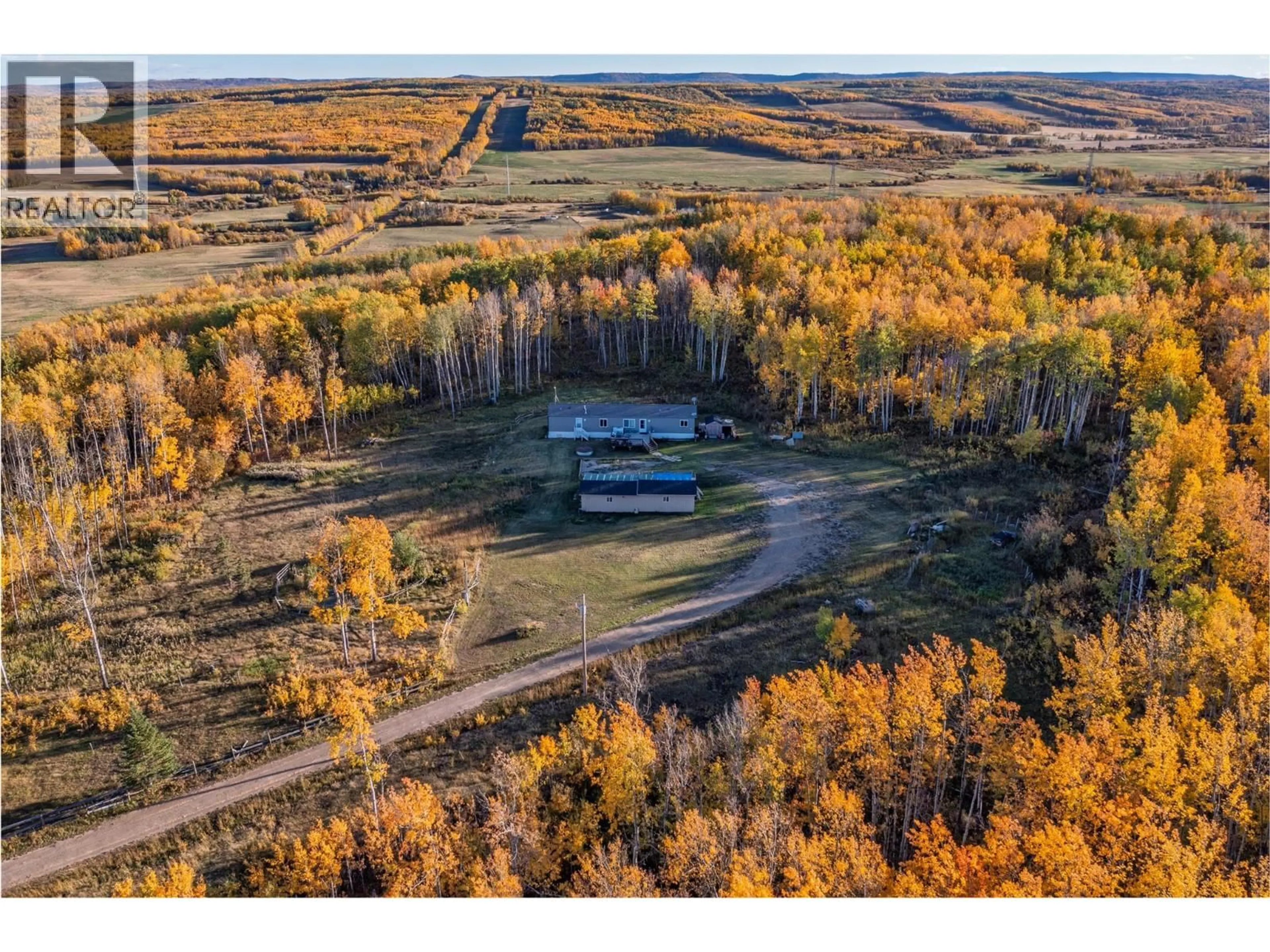 A pic from outside/outdoor area/front of a property/back of a property/a pic from drone, forest/trees view for 10111 253 ROAD, Dawson Creek British Columbia V0C2E0