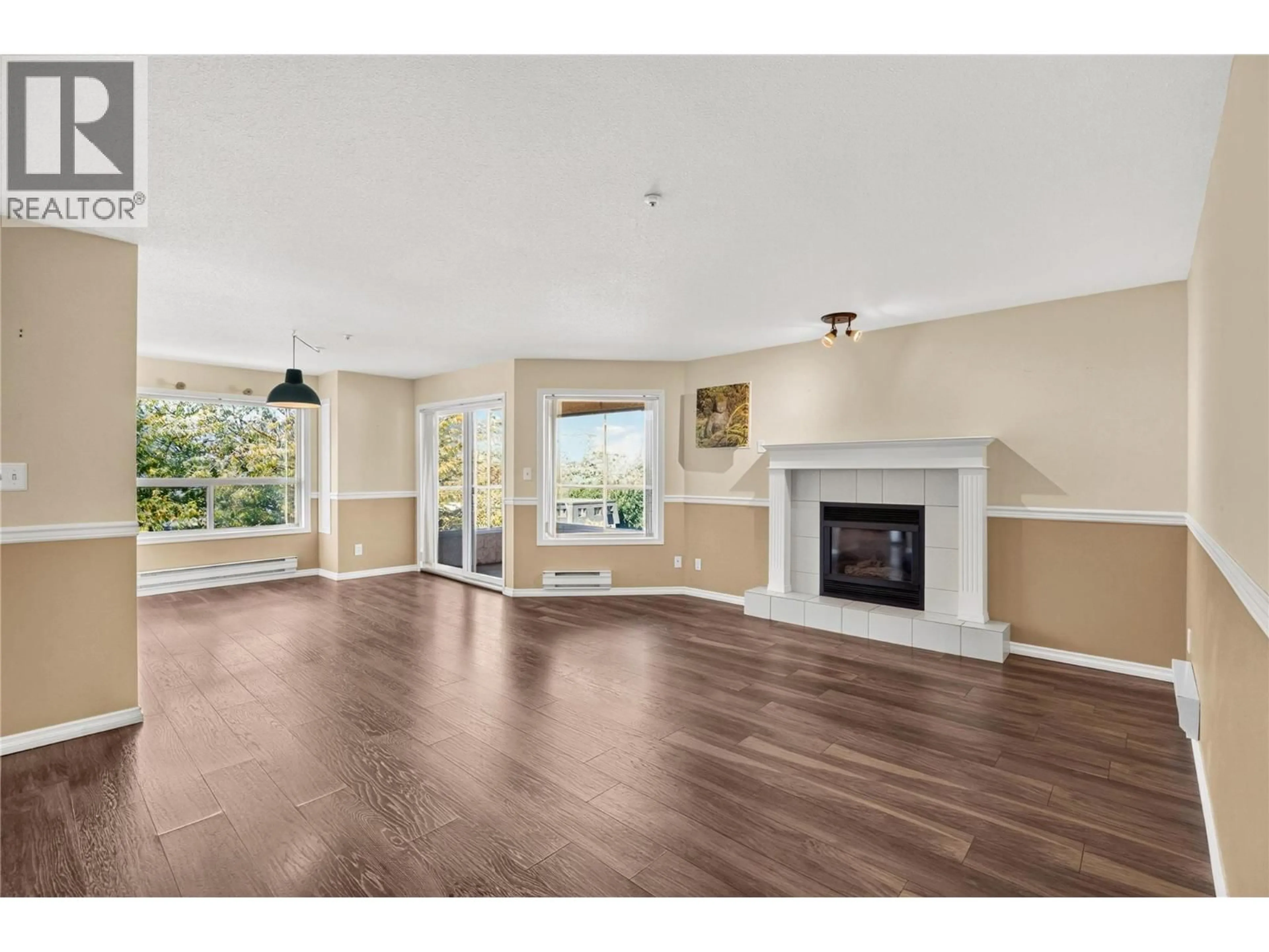 Living room with furniture, wood/laminate floor for 301 - 1750 ATKINSON STREET, Penticton British Columbia V2A7M6
