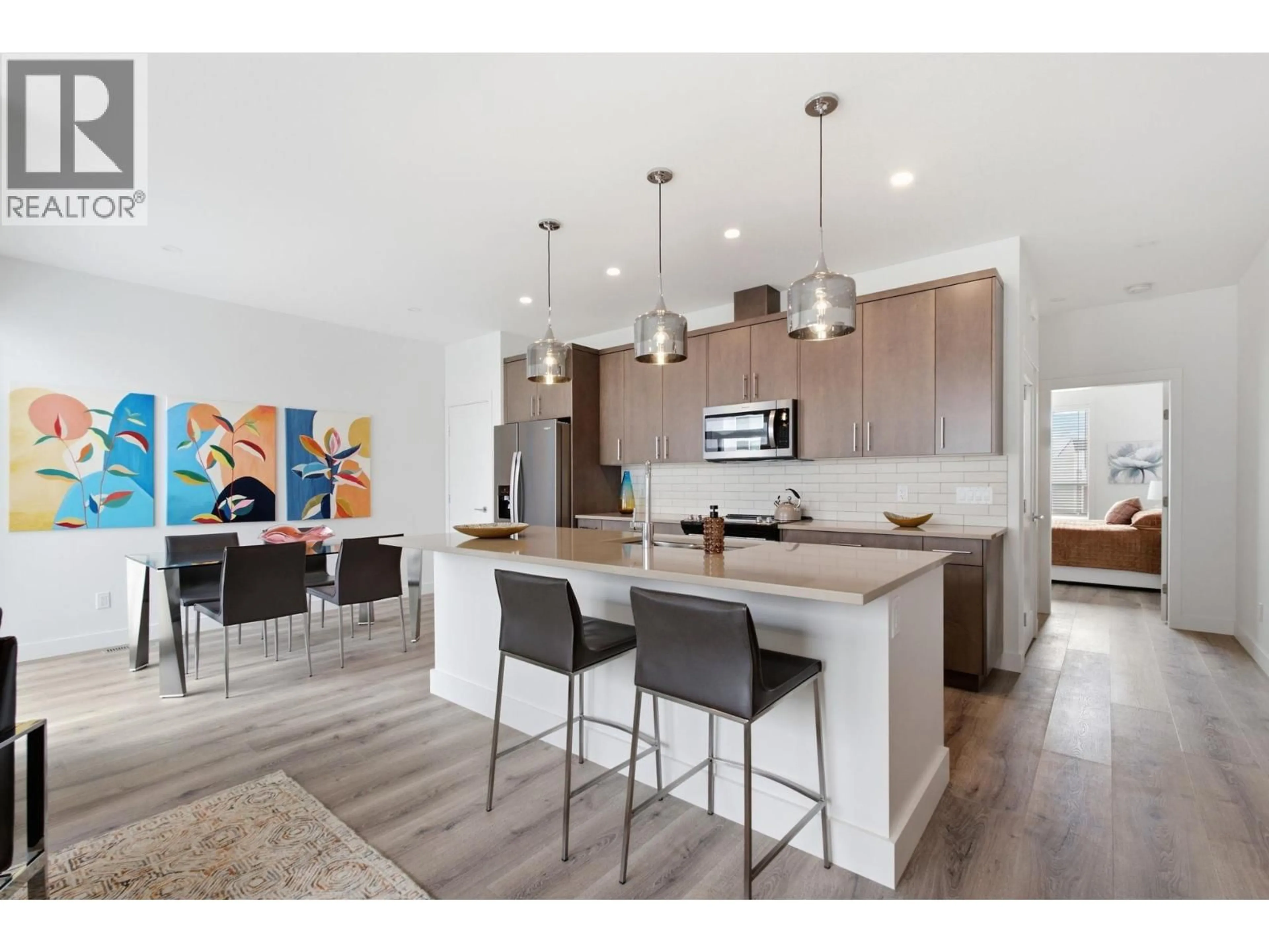 Open concept kitchen, wood/laminate floor for 120 - 610 ACADEMY WAY, Kelowna British Columbia V1V9T1
