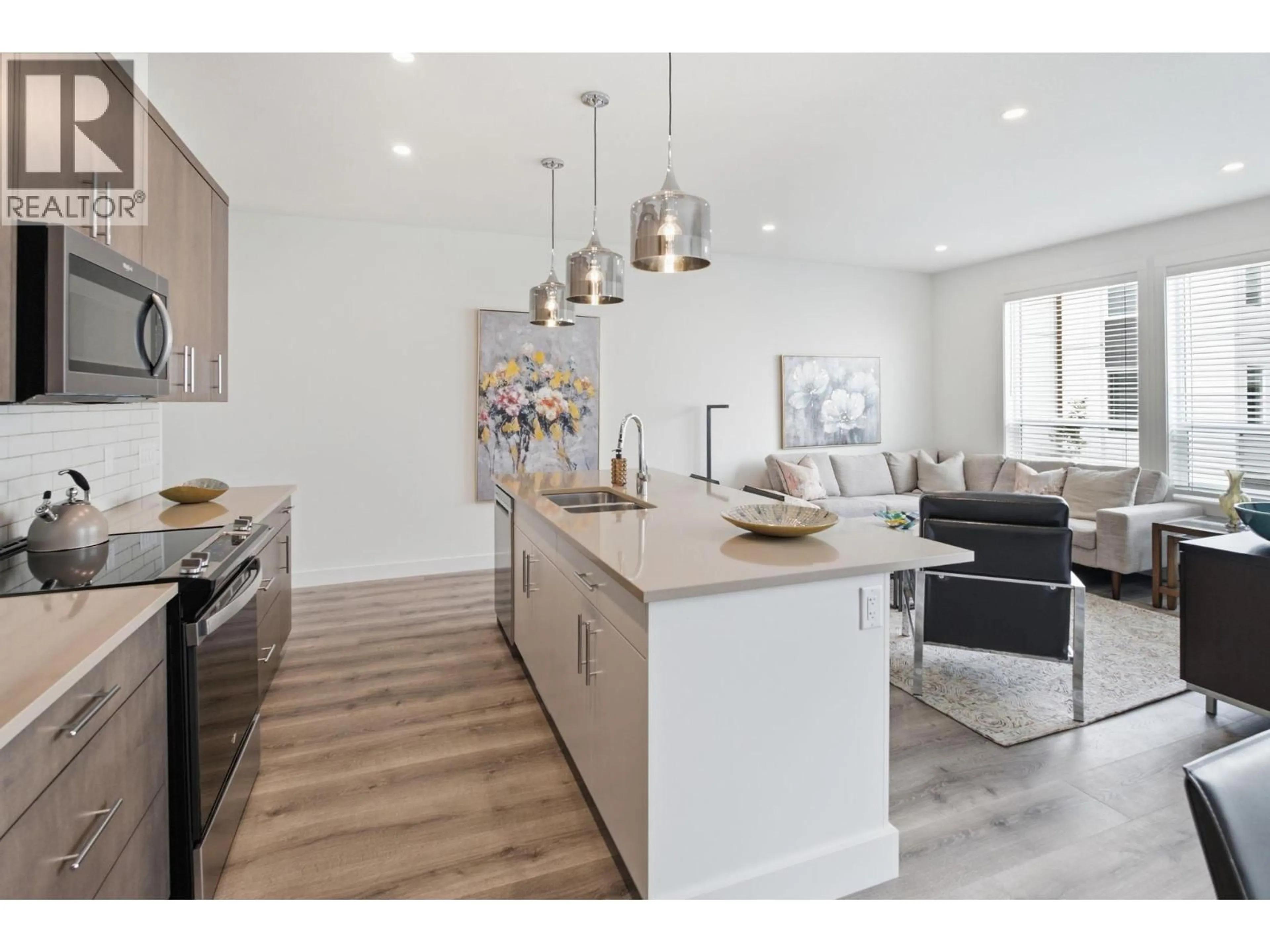 Open concept kitchen, wood/laminate floor for 120 - 610 ACADEMY WAY, Kelowna British Columbia V1V9T1